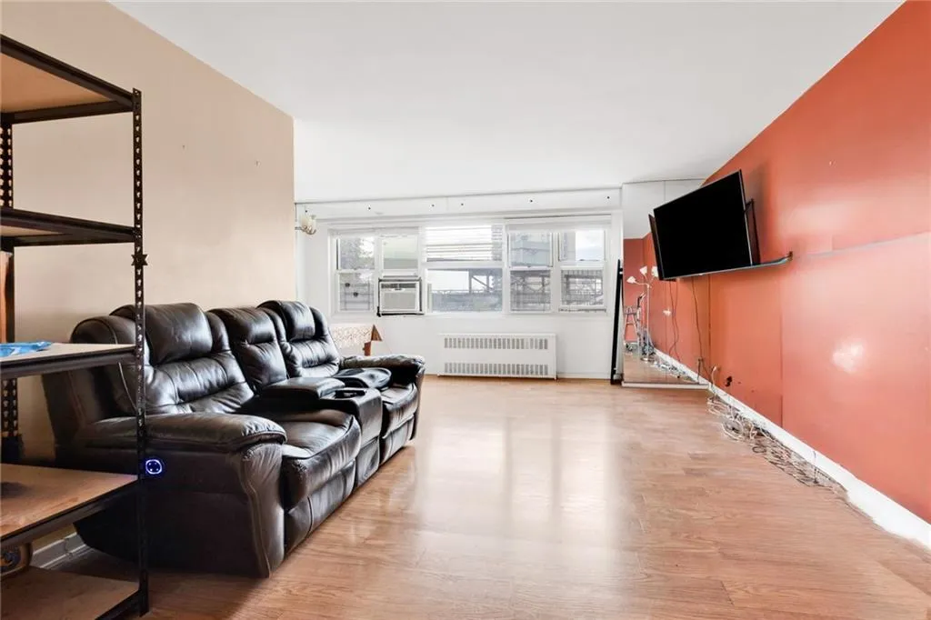 Living room featuring wood finished floors and radiator Living room featuring wood finished floors and radiator
