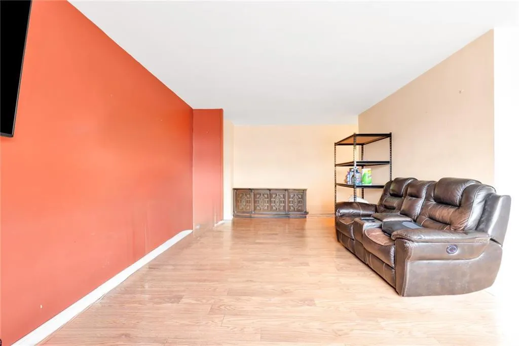 Living room featuring wood finished floors and baseboards Living room featuring wood finished floors and baseboards