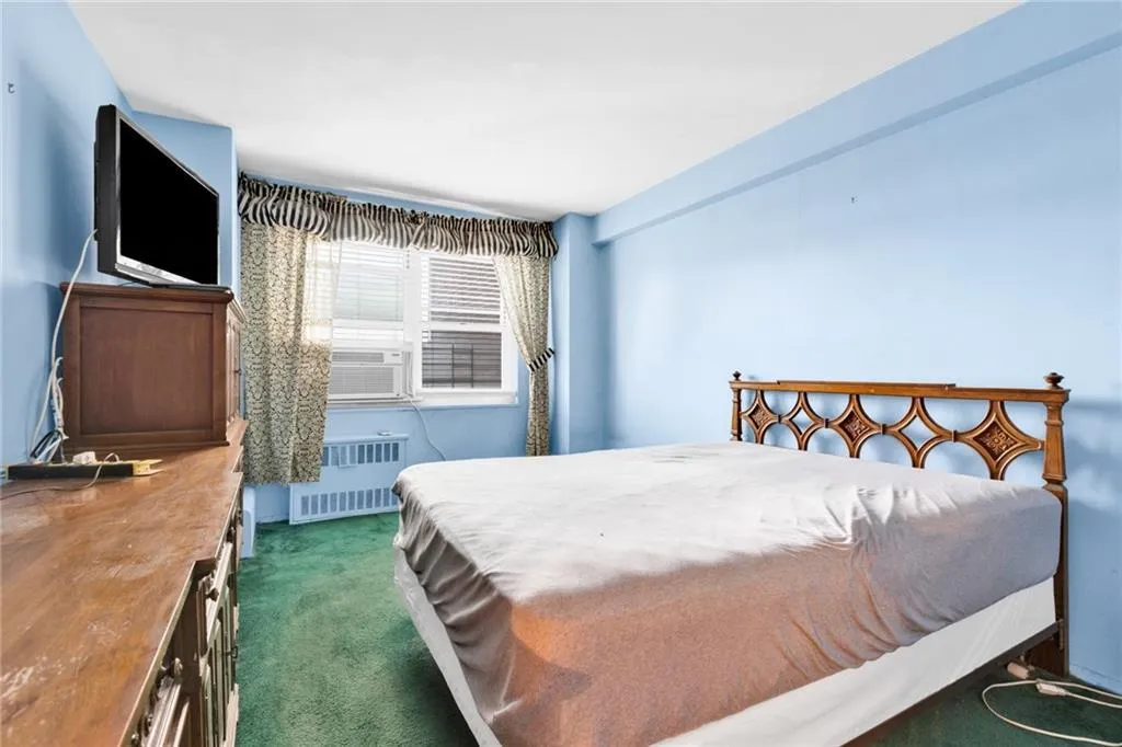Bedroom with carpet, radiator heating unit, and cooling unit Bedroom with carpet, radiator heating unit, and cooling unit