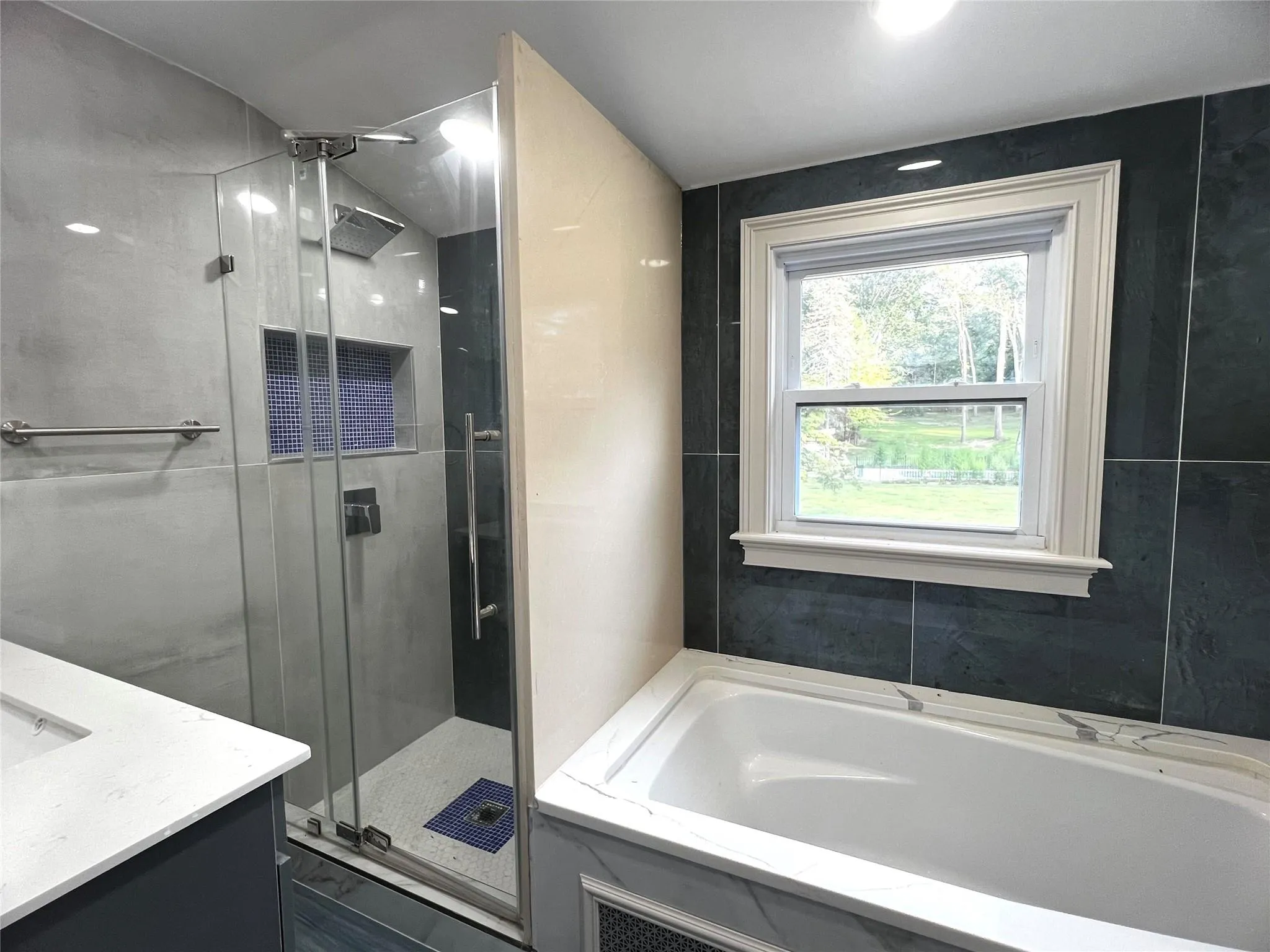 Full bath featuring a shower stall, vanity, and a bath Full bath featuring a shower stall, vanity, and a bath