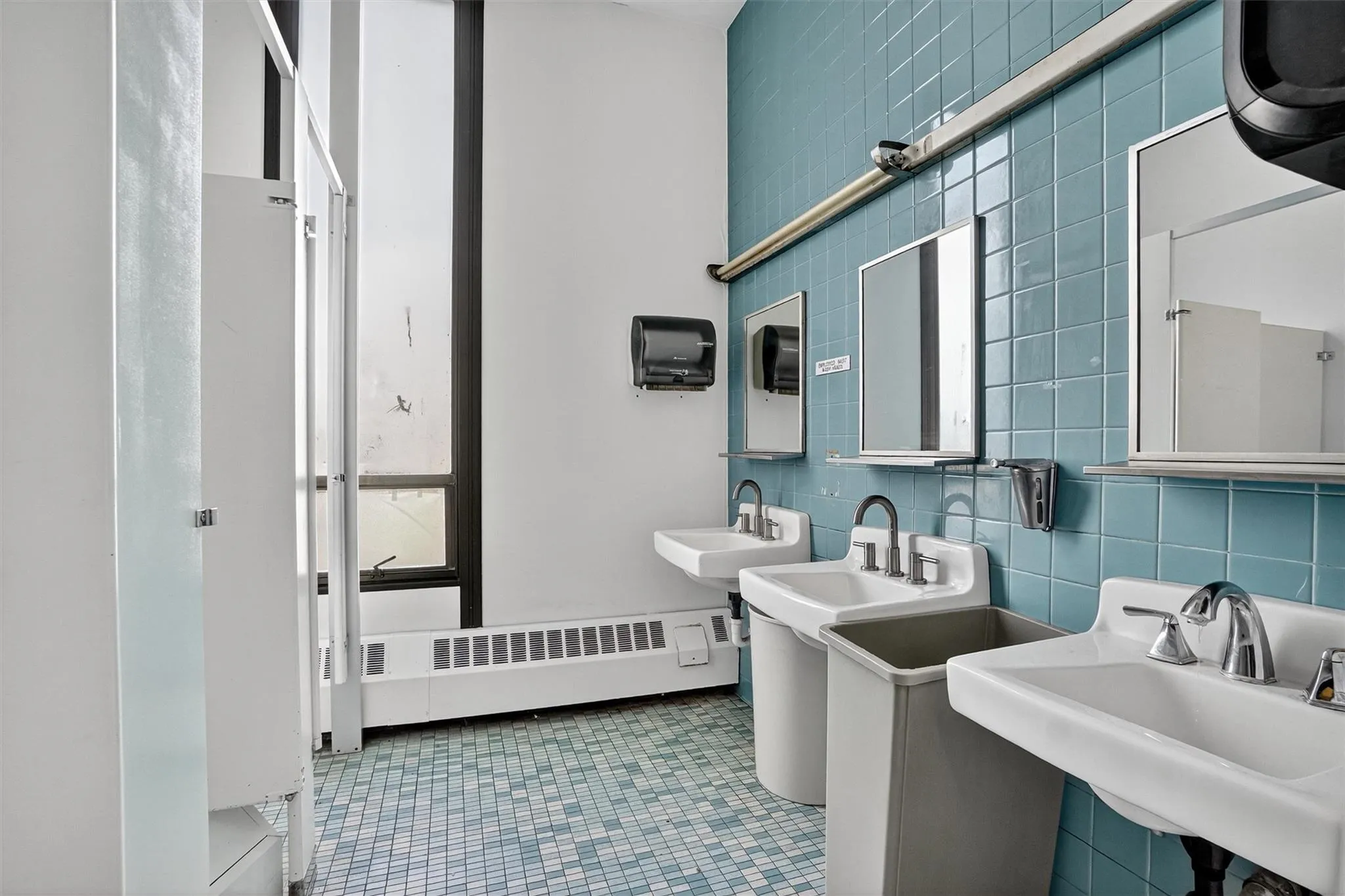 Bathroom featuring tile walls and baseboard heating Bathroom featuring tile walls and baseboard heating