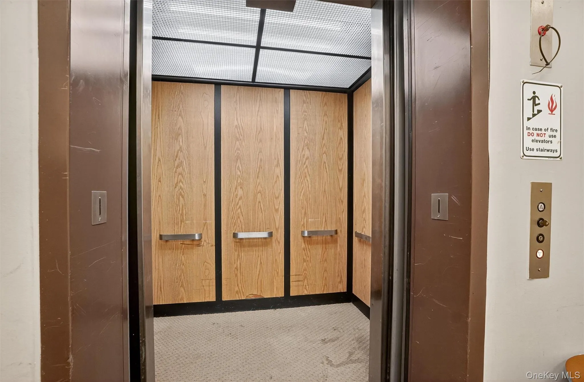 Elevator featuring carpet floors Elevator featuring carpet floors