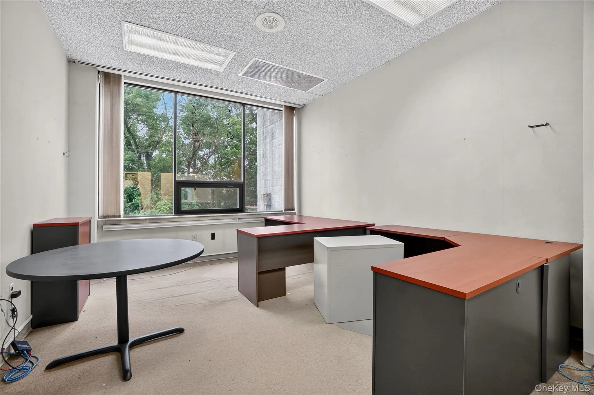 Unfurnished office with a textured ceiling and light colored carpet Unfurnished office with a textured ceiling and light colored carpet