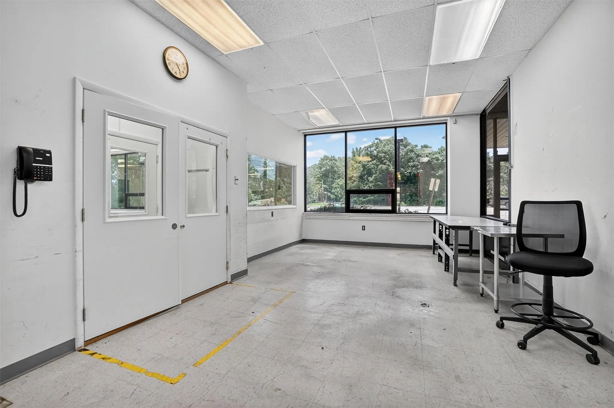 Unfurnished office featuring baseboards and a paneled ceiling Unfurnished office featuring baseboards and a paneled ceiling