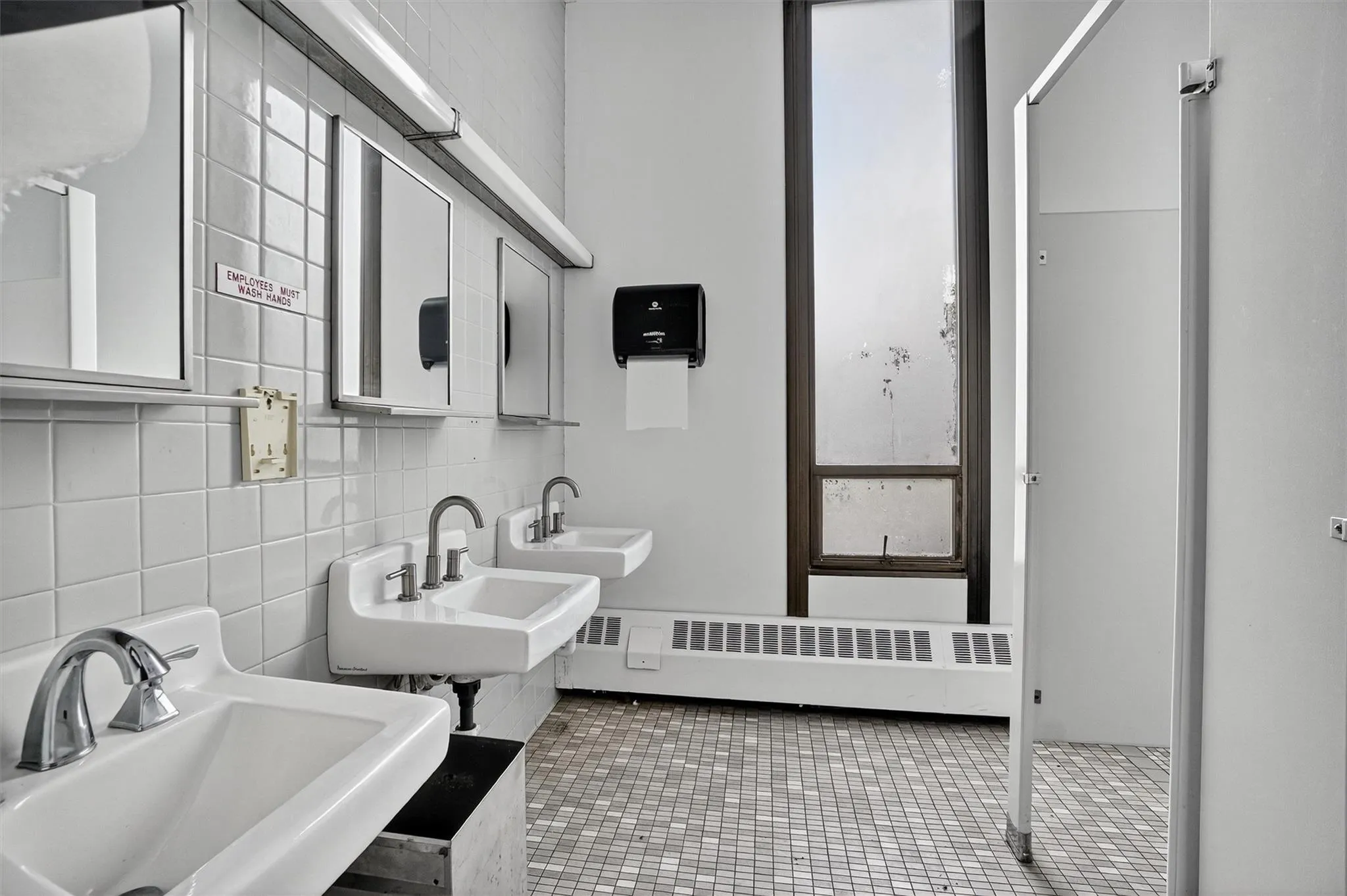 Bathroom with decorative backsplash and tile patterned floors Bathroom with decorative backsplash and tile patterned floors
