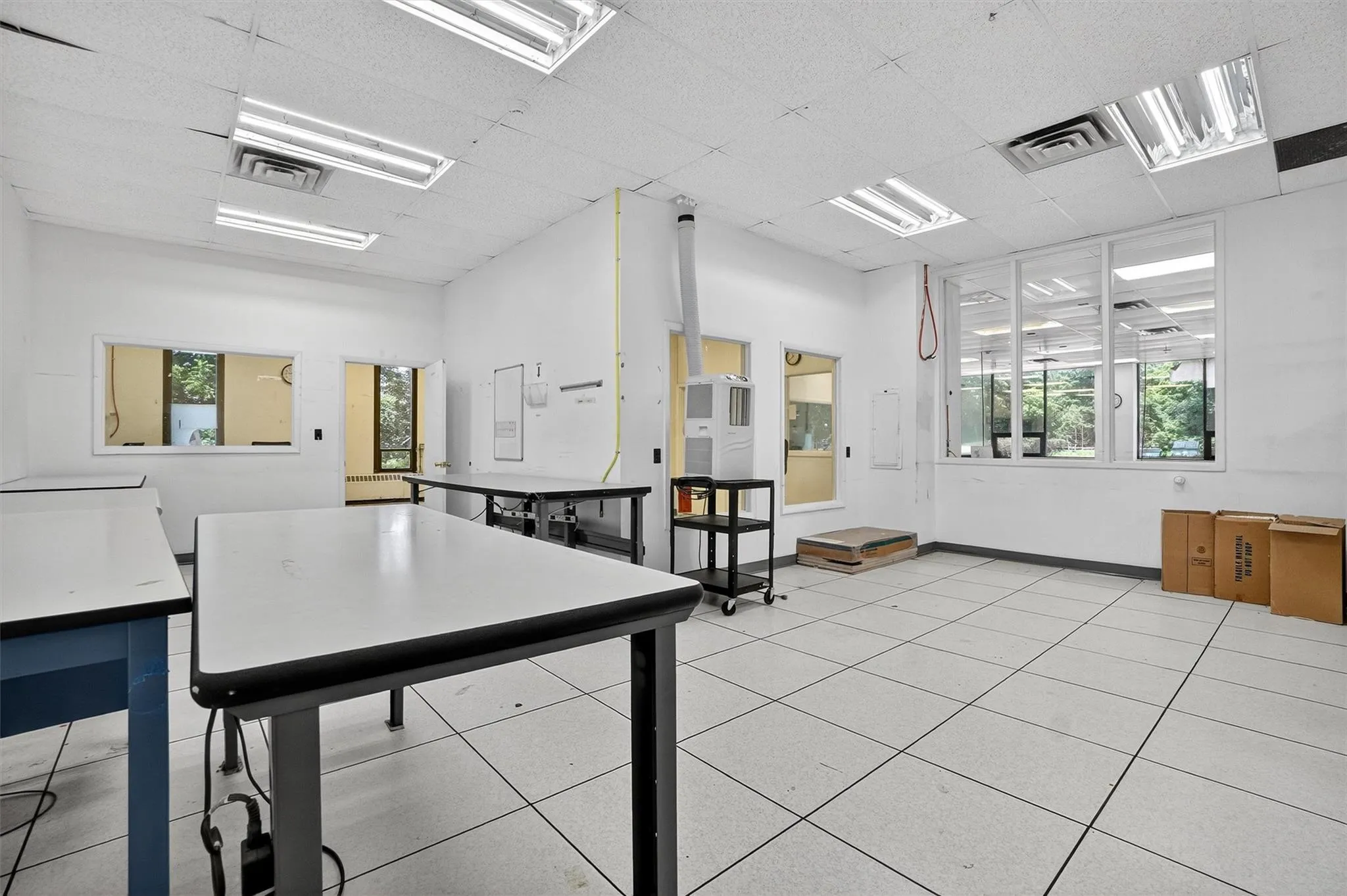 Office space featuring a drop ceiling and baseboards Office space featuring a drop ceiling and baseboards