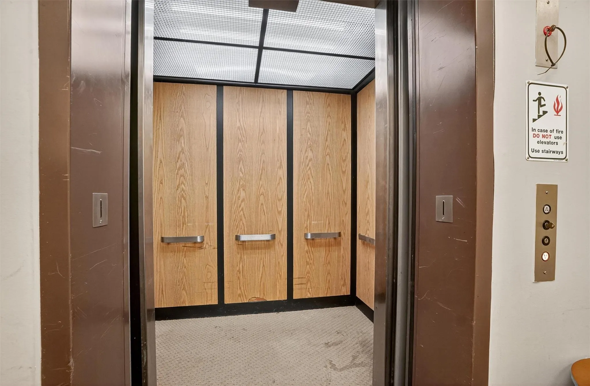 Elevator featuring carpet floors Elevator featuring carpet floors