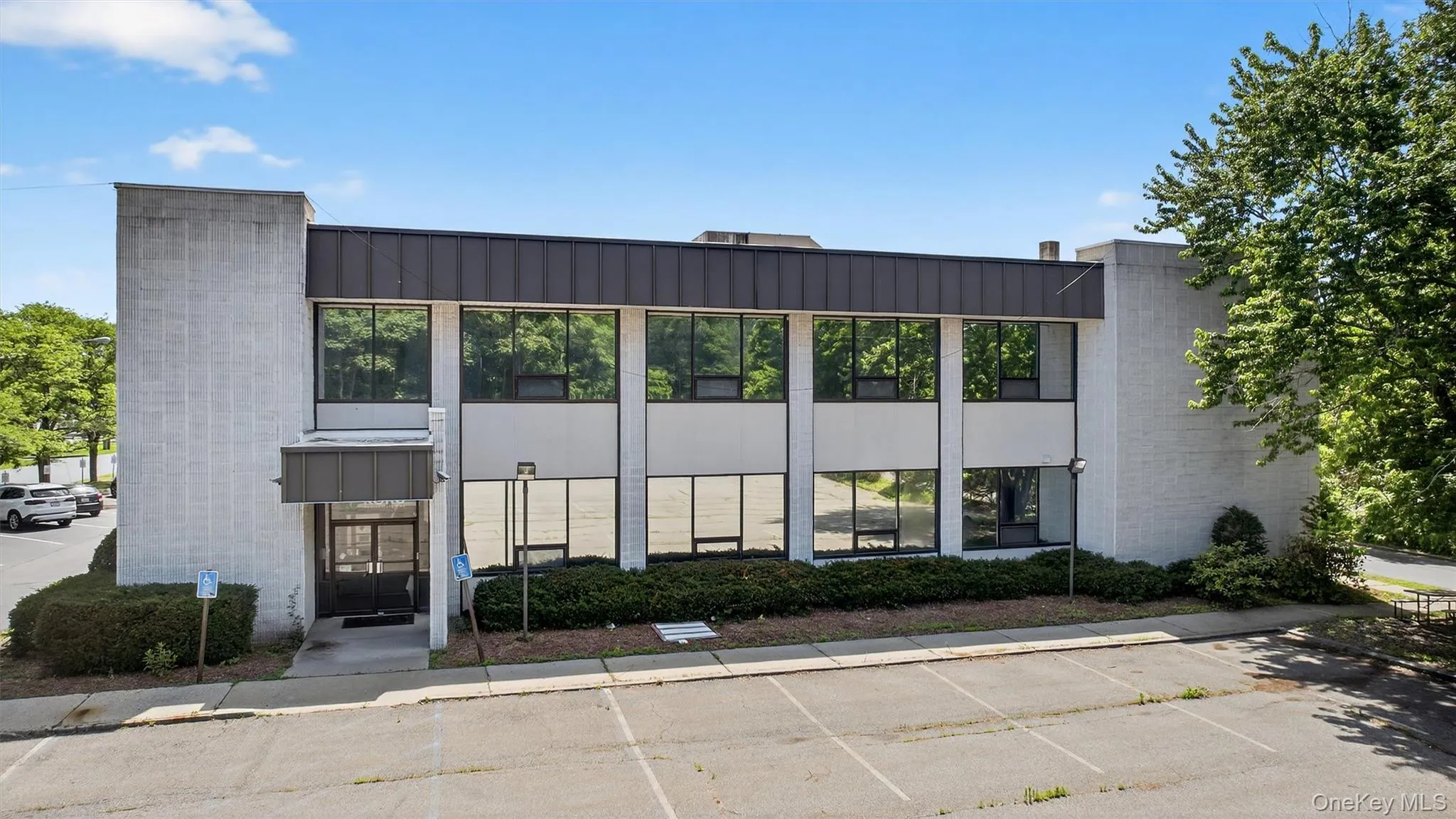 View of building exterior with uncovered parking View of building exterior with uncovered parking