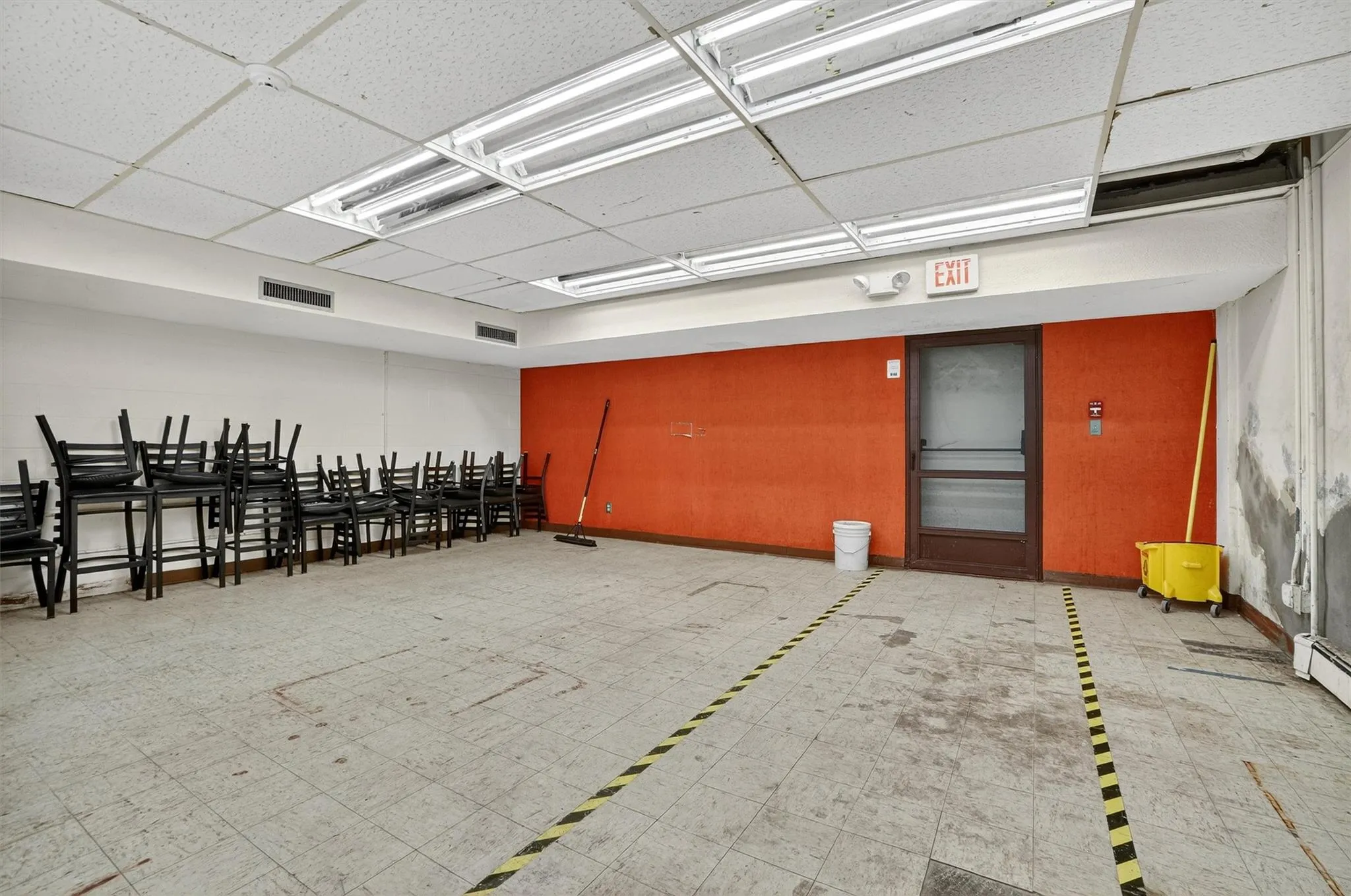 Miscellaneous room featuring a drop ceiling and baseboards Miscellaneous room featuring a drop ceiling and baseboards