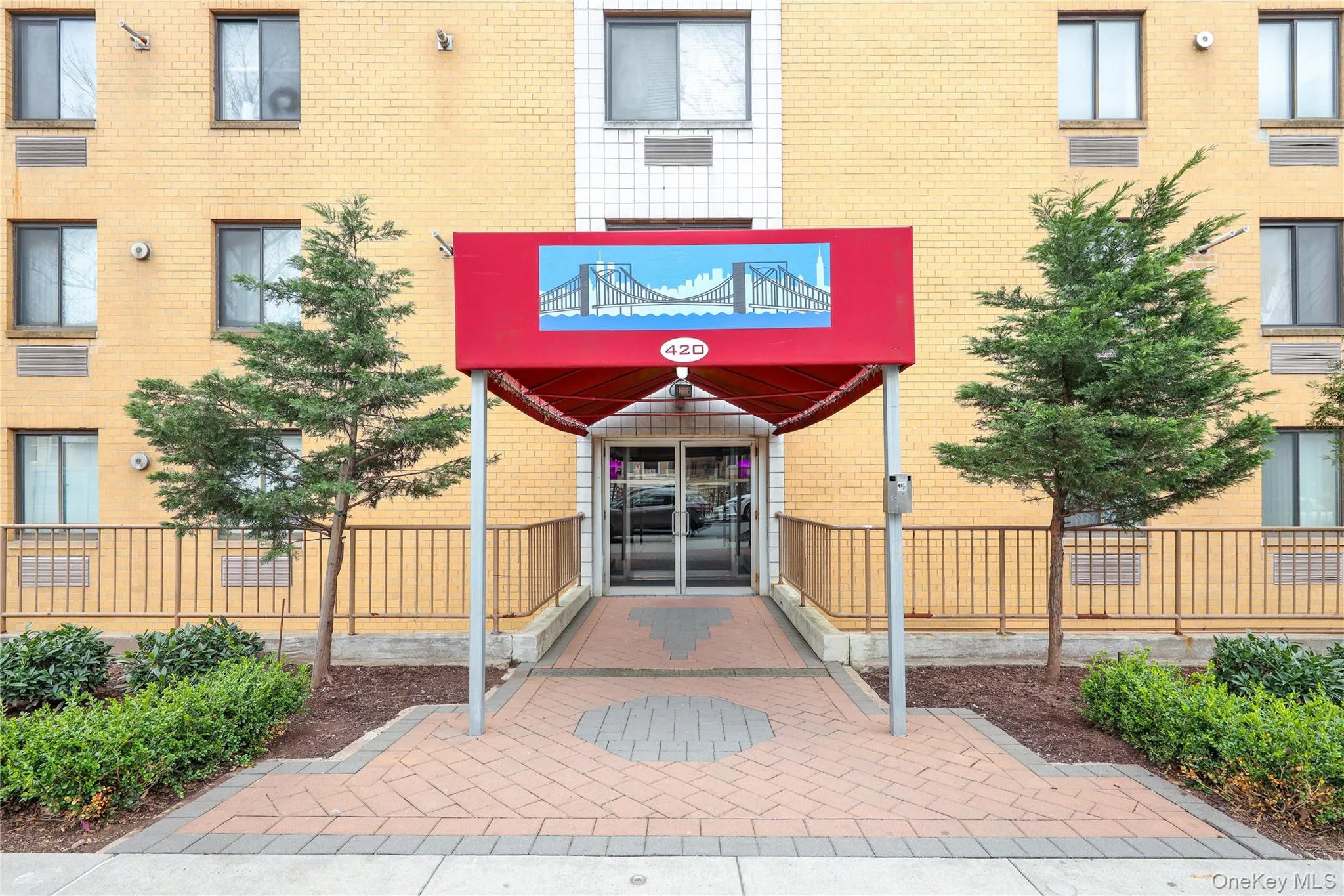 Doorway to property with brick siding and a balcony Doorway to property with brick siding and a balcony