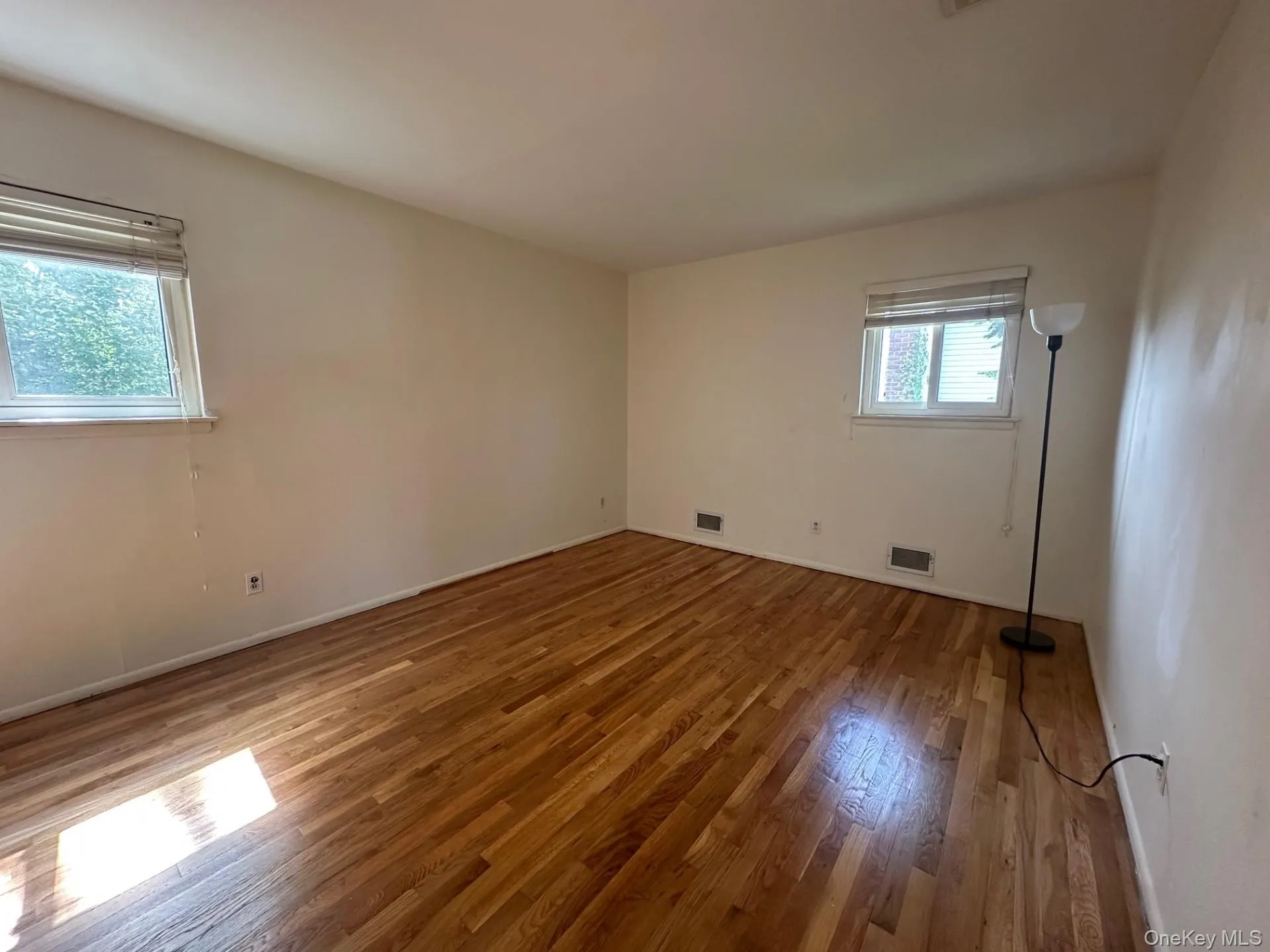 Empty room with wood finished floors and baseboards Empty room with wood finished floors and baseboards