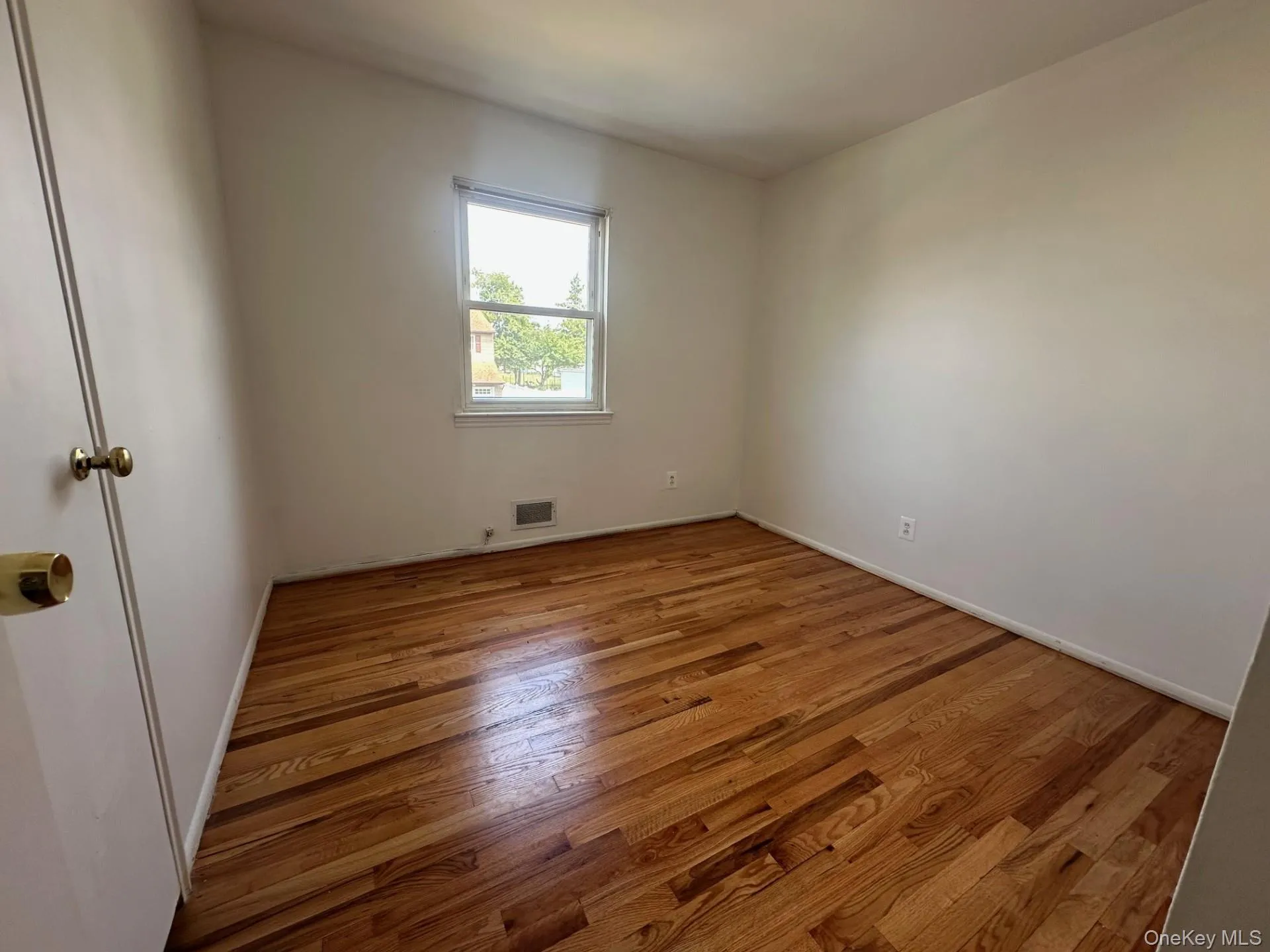 Unfurnished room featuring light wood finished floors and baseboards Unfurnished room featuring light wood finished floors and baseboards