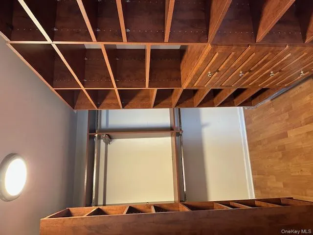 Walk in closet with light wood-style floors Walk in closet with light wood-style floors