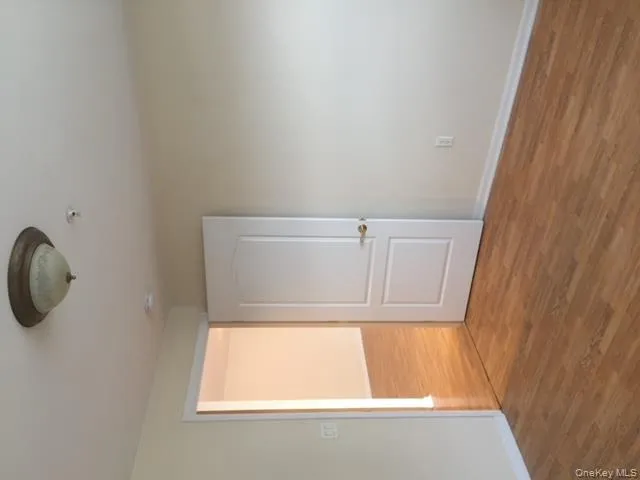 Spare room with wood finished floors and baseboards Spare room with wood finished floors and baseboards