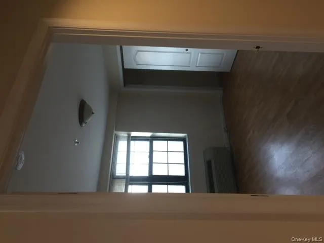 Unfurnished room featuring wood finished floors and an AC wall unit Unfurnished room featuring wood finished floors and an AC wall unit