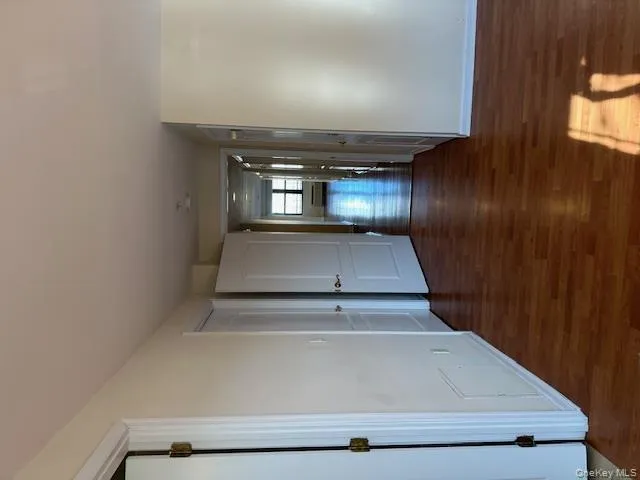 Corridor with dark wood-style flooring and baseboards Corridor with dark wood-style flooring and baseboards