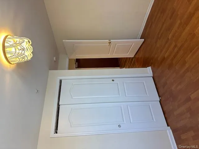 Unfurnished bedroom featuring dark wood-style floors and a closet Unfurnished bedroom featuring dark wood-style floors and a closet