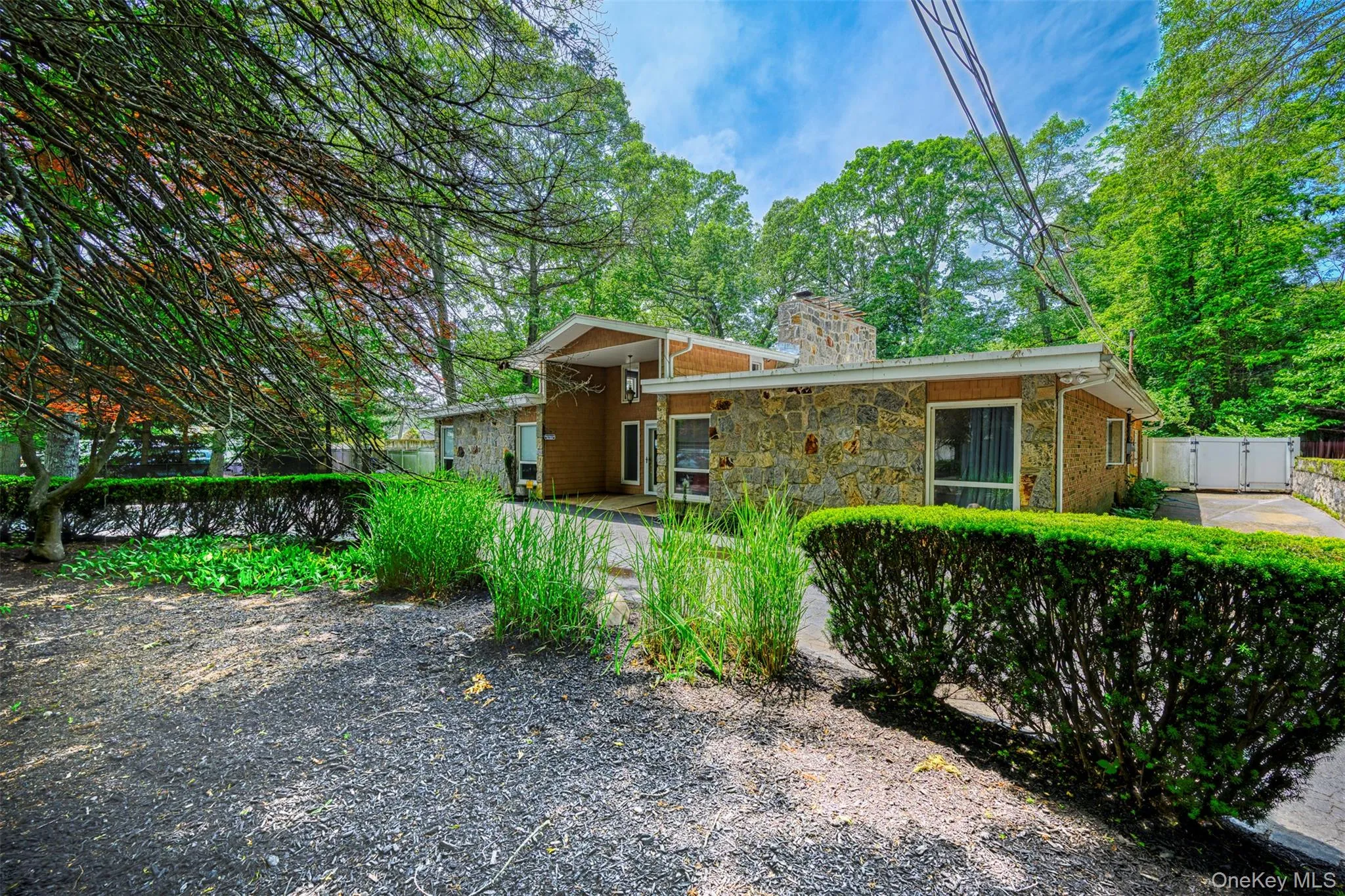 View of front of property with a chimney and stone siding View of front of property with a chimney and stone siding