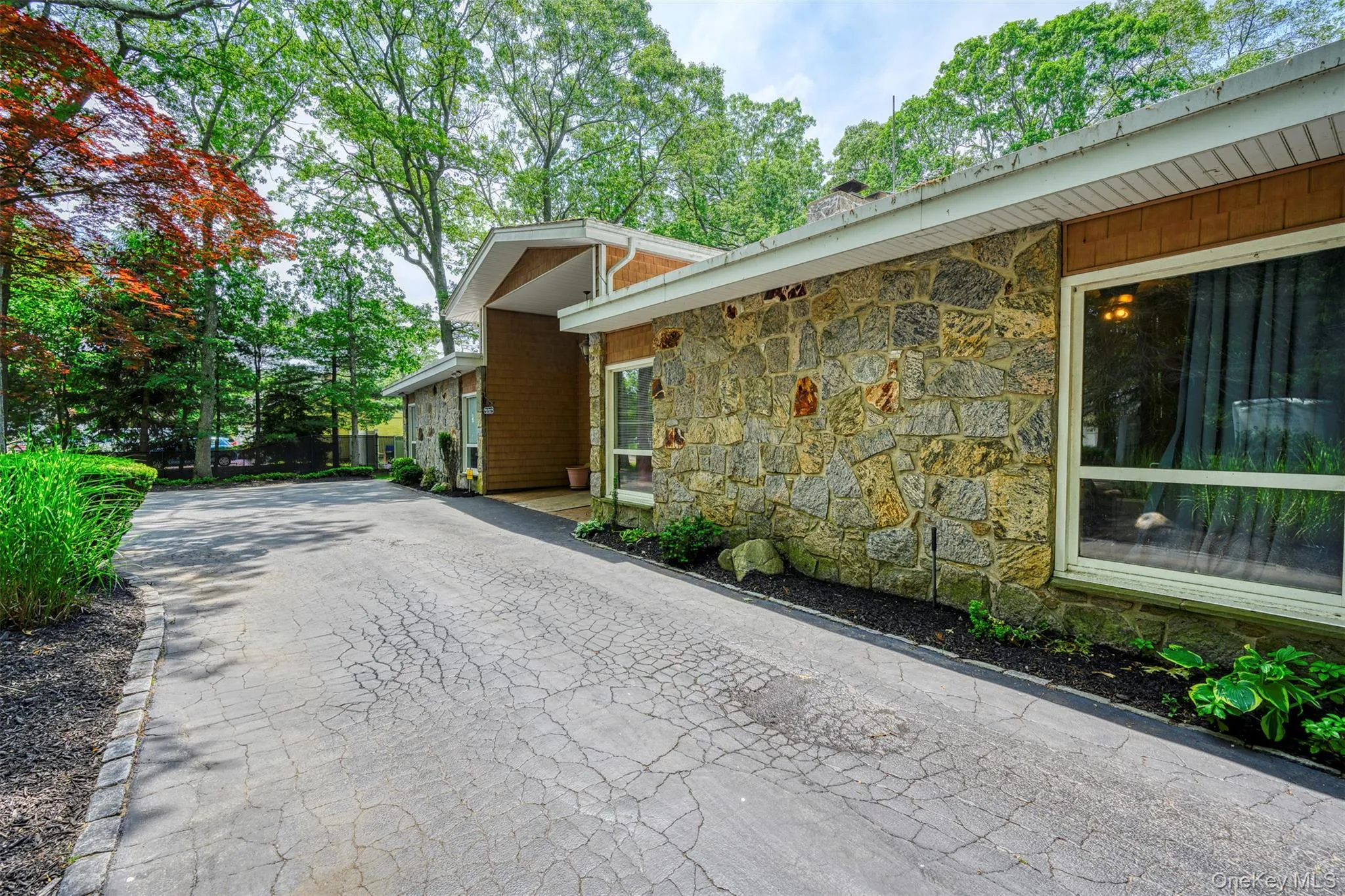 View of property exterior featuring stone siding View of property exterior featuring stone siding