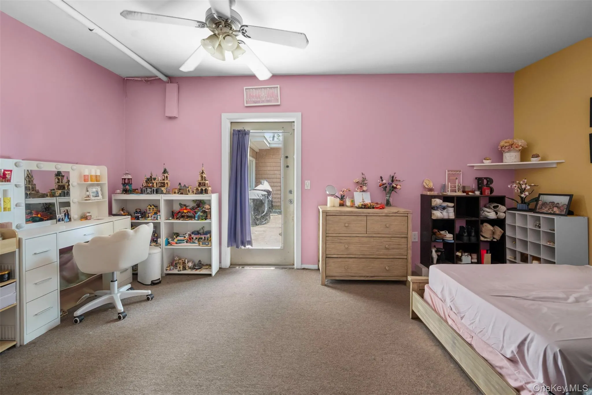 Carpeted bedroom featuring access to exterior and a ceiling fan Carpeted bedroom featuring access to exterior and a ceiling fan