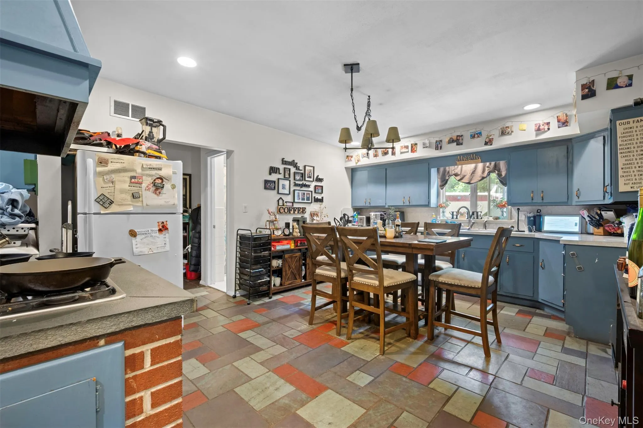 Dining room with recessed lighting and stone tile flooring Dining room with recessed lighting and stone tile flooring