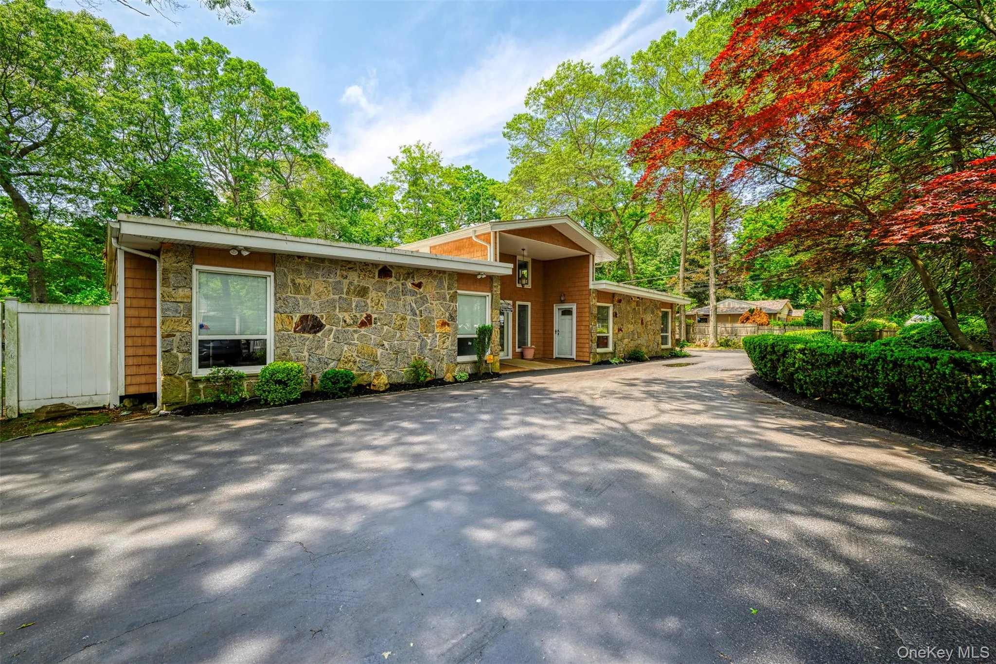 Mid-century modern home featuring stone siding Mid-century modern home featuring stone siding