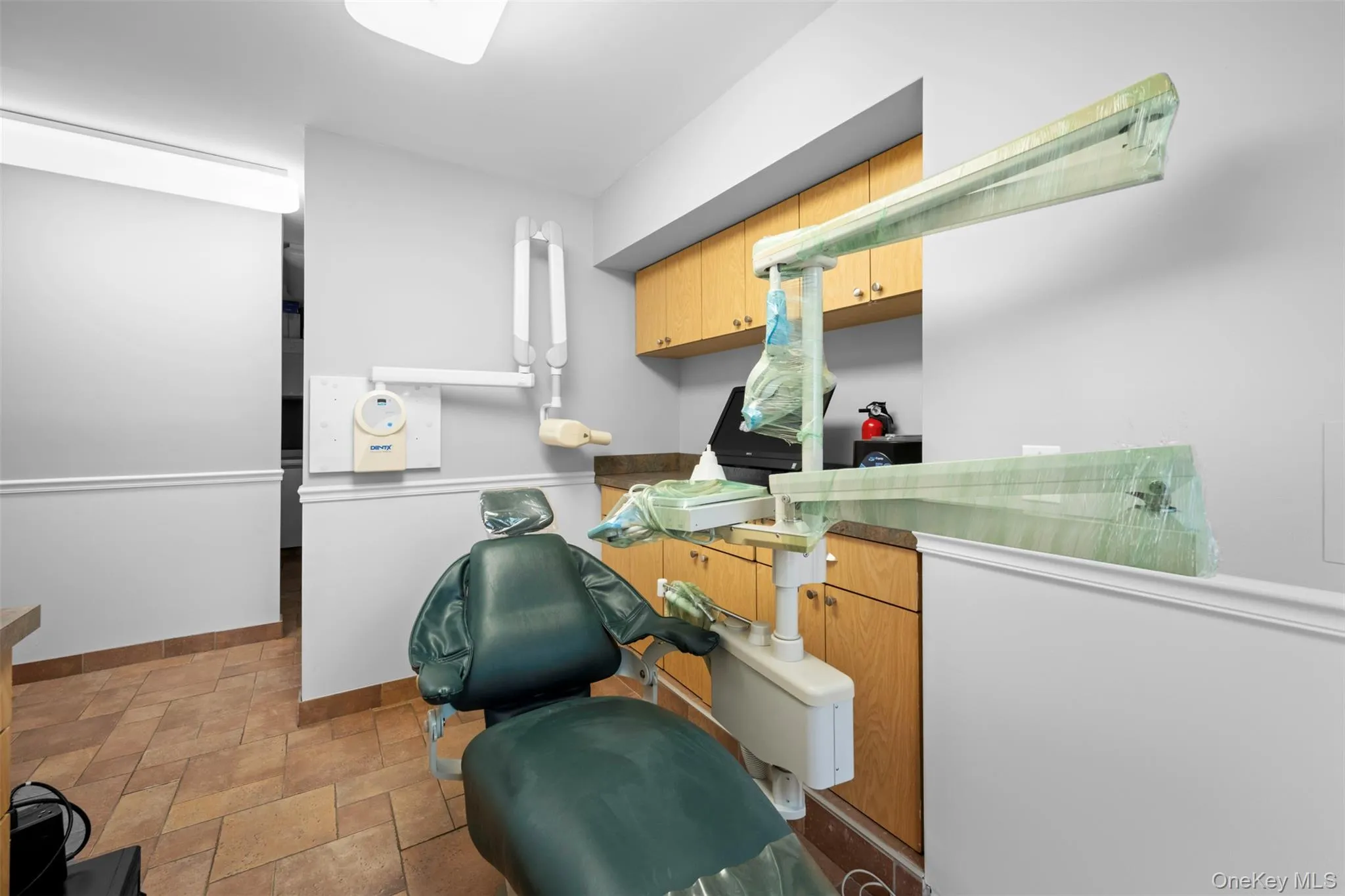 Laundry room with light stone finish flooring and baseboards Laundry room with light stone finish flooring and baseboards