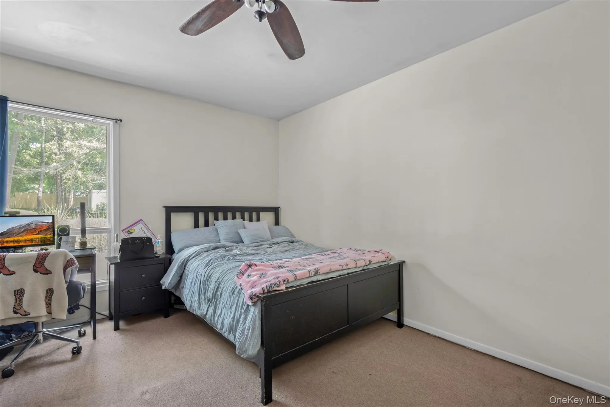 Carpeted bedroom with baseboards and ceiling fan Carpeted bedroom with baseboards and ceiling fan