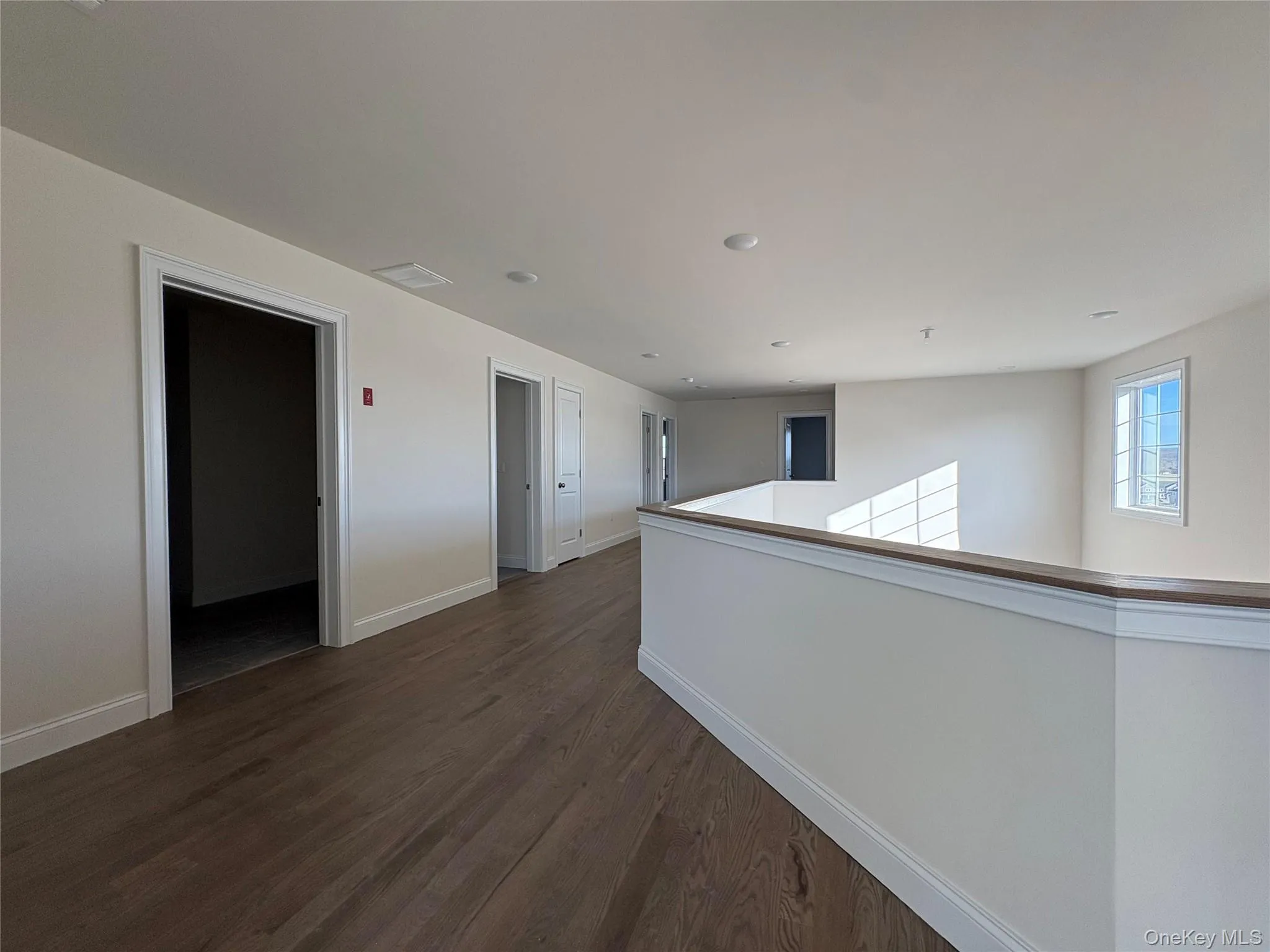 Spare room featuring dark wood finished floors and baseboards Spare room featuring dark wood finished floors and baseboards