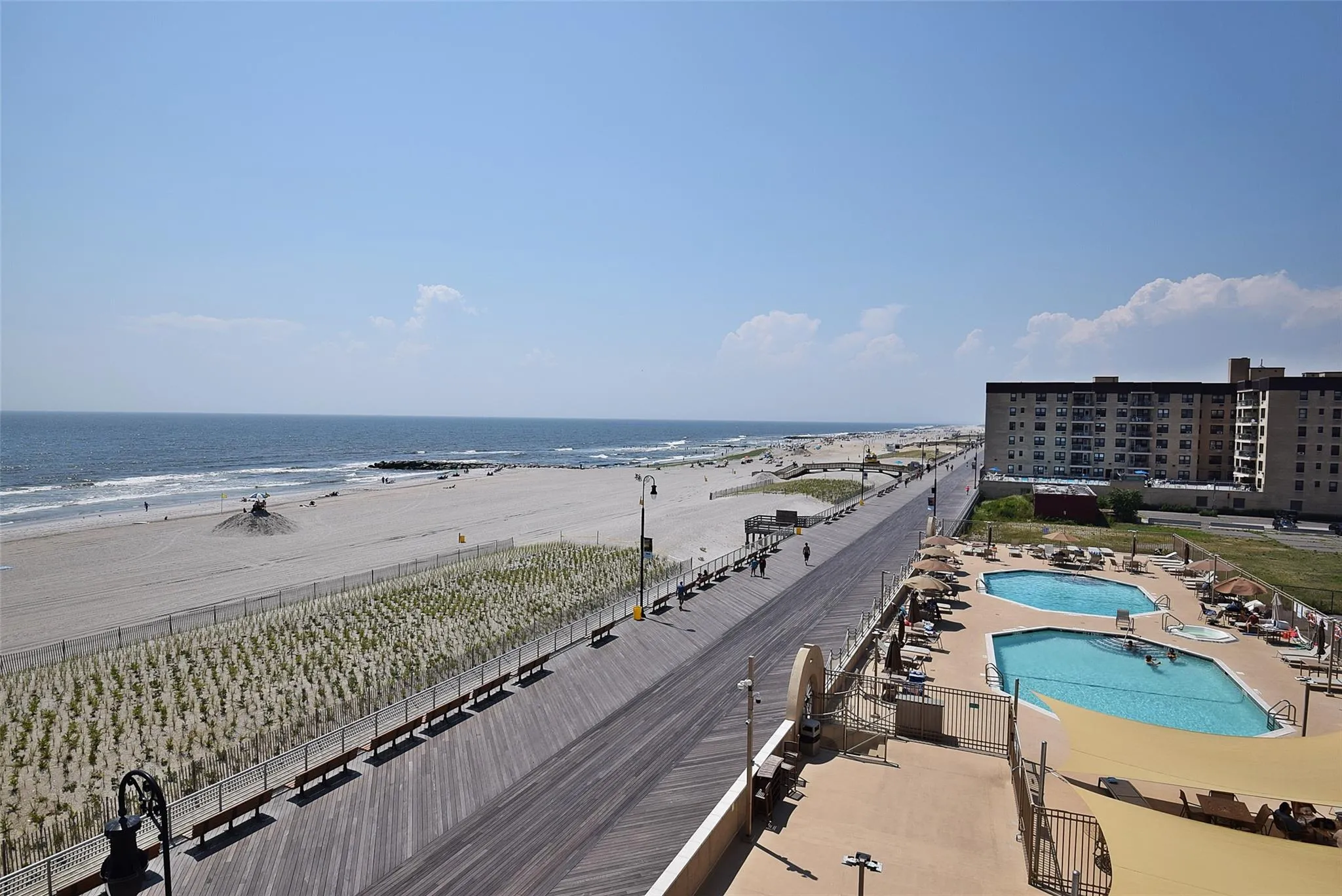 Bird's eye view of extended coastline and a pool area Bird's eye view of extended coastline and a pool area
