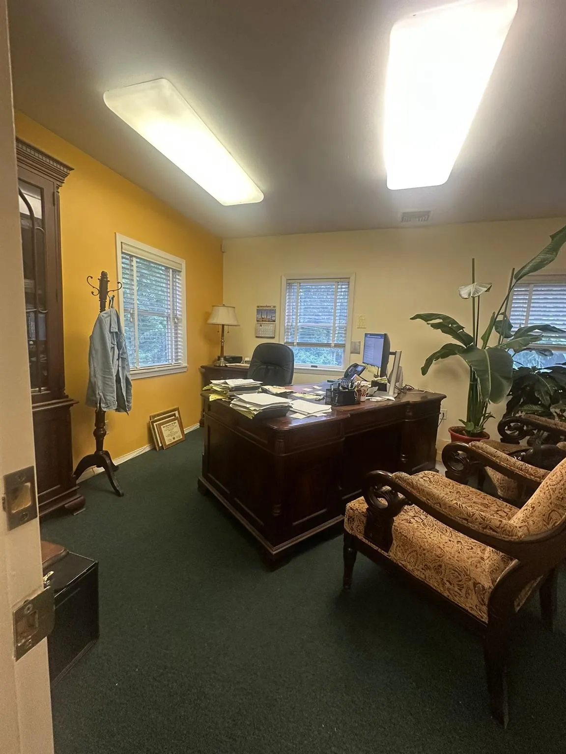 Carpeted office space featuring baseboards Carpeted office space featuring baseboards