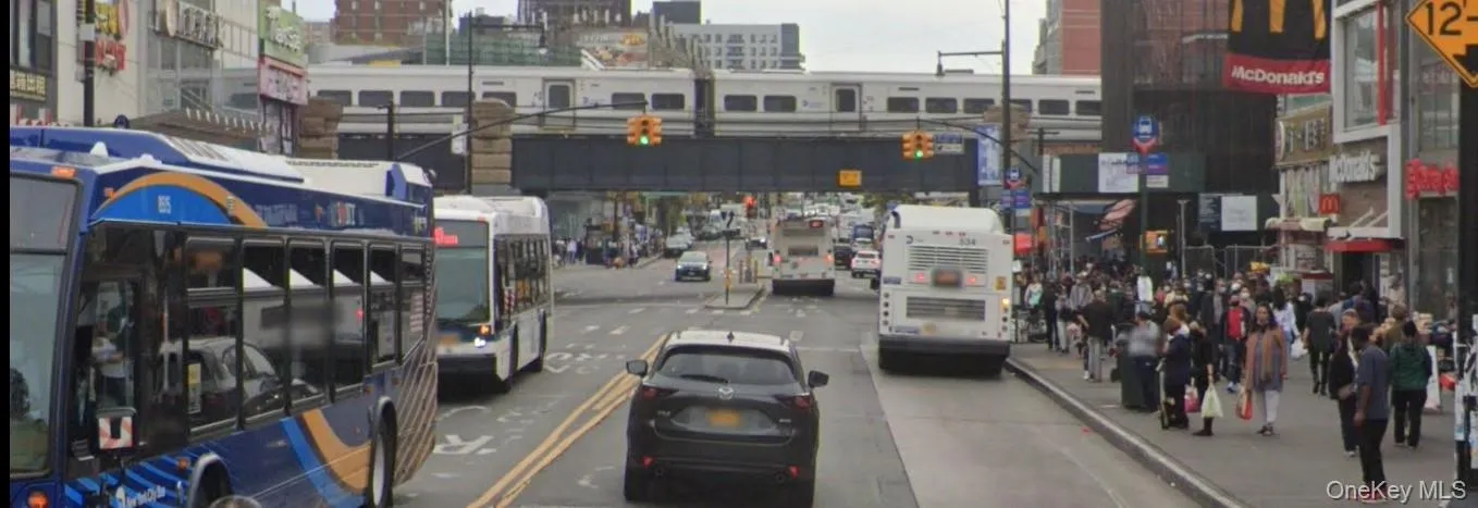 View of asphalt road with a view of city and street lights View of asphalt road with a view of city and street lights