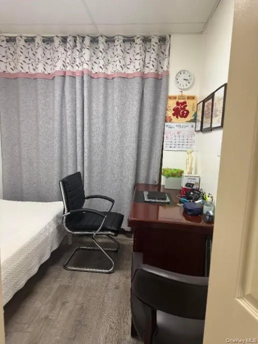 Bedroom featuring a desk and wood finished floors Bedroom featuring a desk and wood finished floors