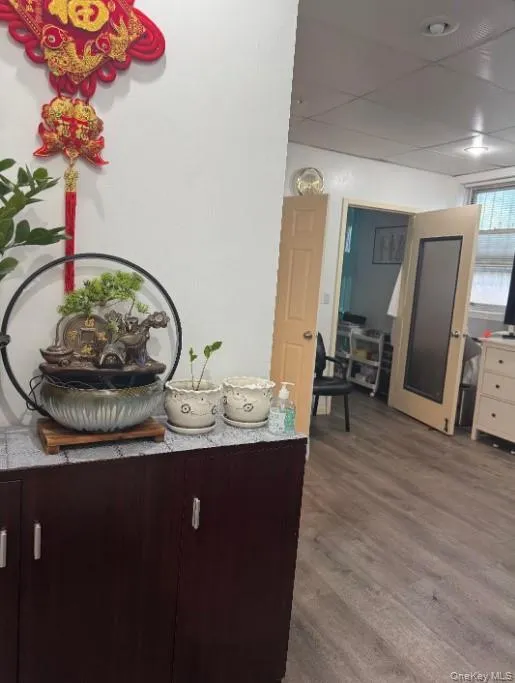 Detailed view of wood finished floors and a drop ceiling Detailed view of wood finished floors and a drop ceiling