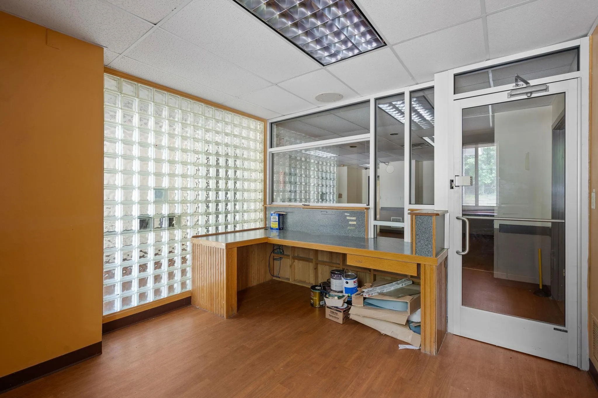 Office area featuring wood finished floors and a paneled ceiling Office area featuring wood finished floors and a paneled ceiling