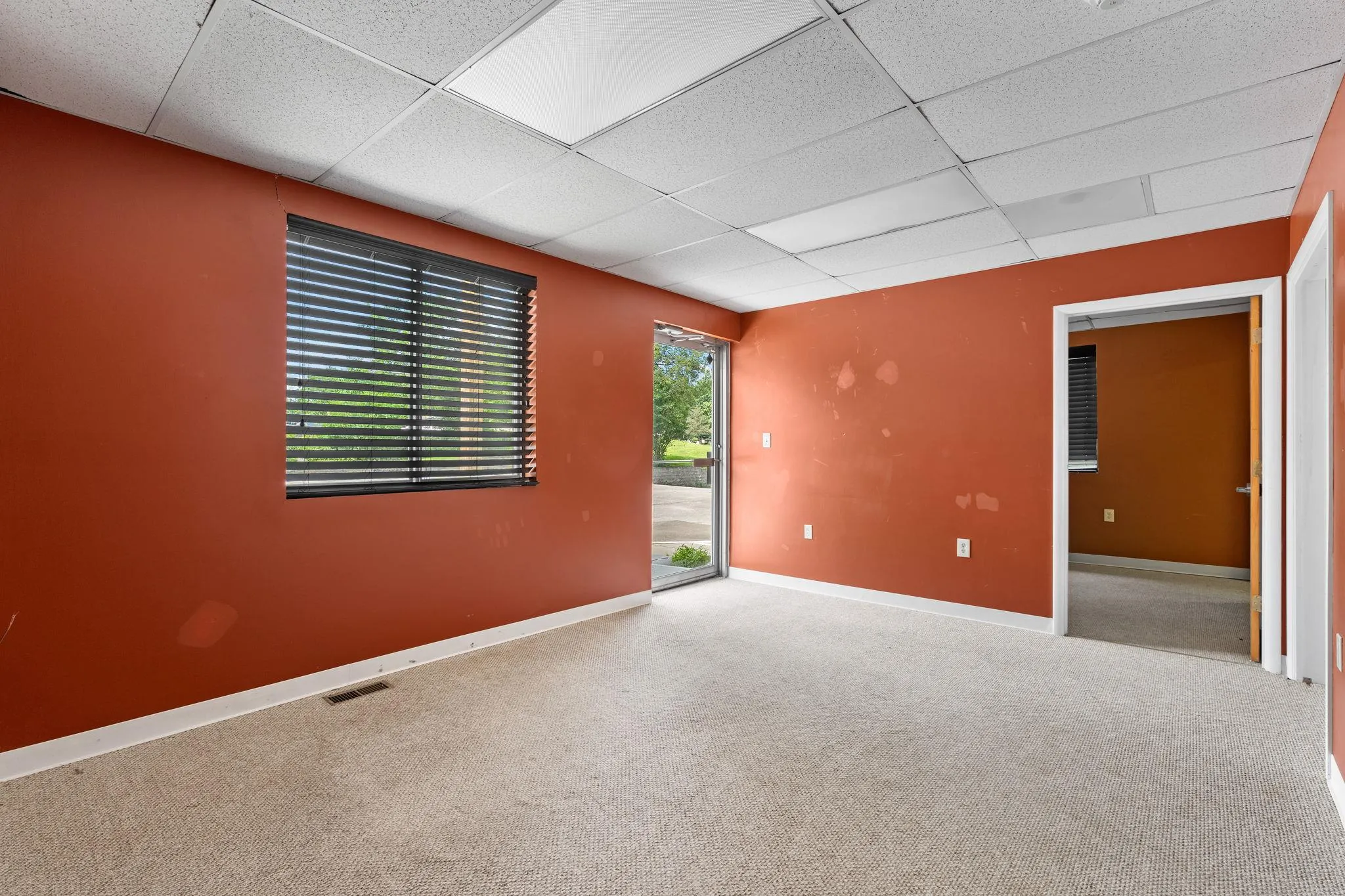 Empty room with a drop ceiling and carpet Empty room with a drop ceiling and carpet