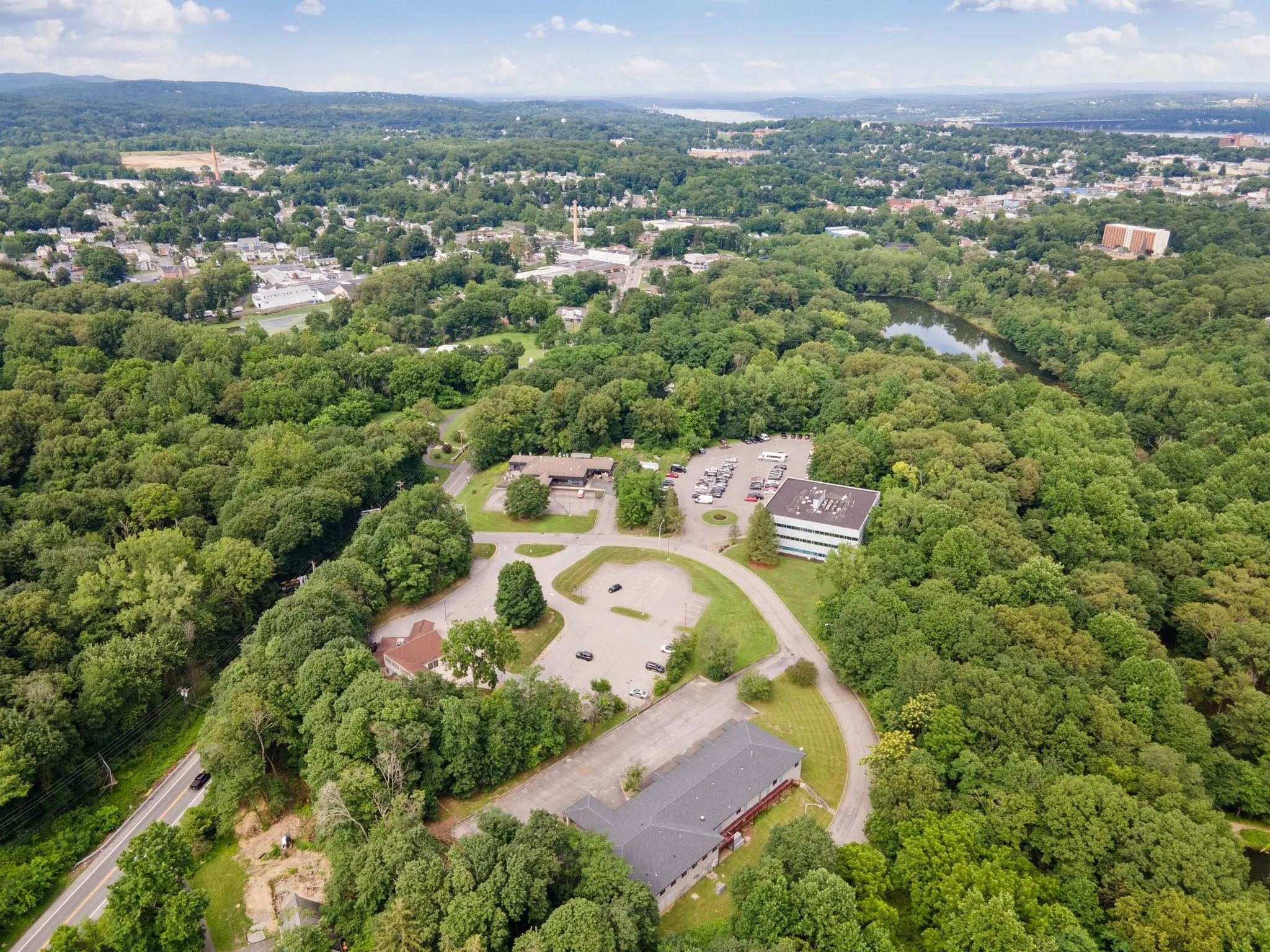 Aerial overview of property\'s location featuring a heavily wooded area Aerial overview of property\'s location featuring a heavily wooded area