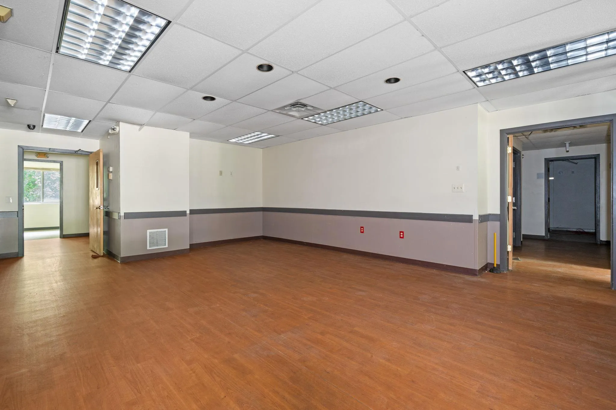 Spare room with wood finished floors and a paneled ceiling Spare room with wood finished floors and a paneled ceiling