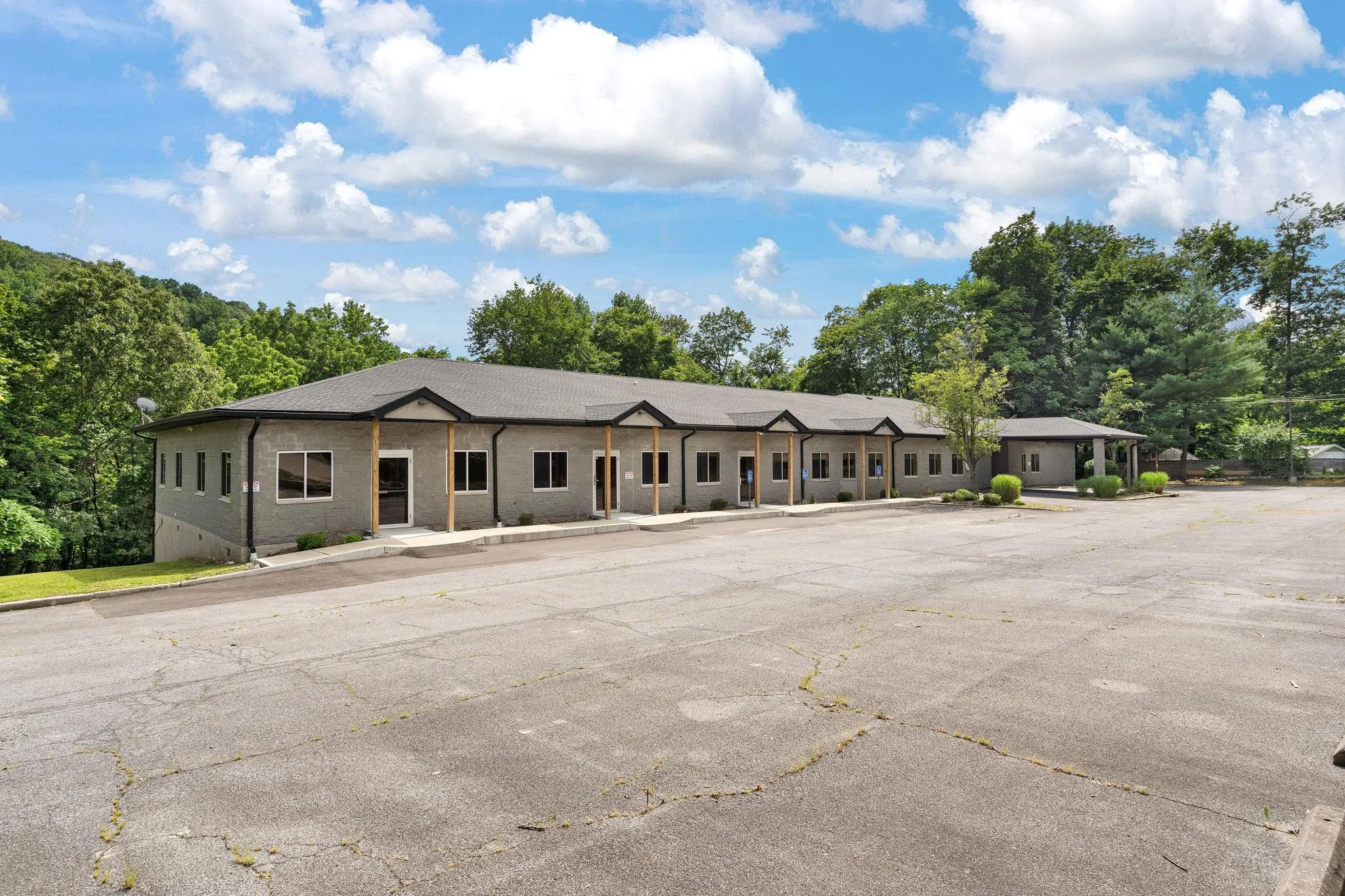 View of front of house with uncovered parking and brick siding View of front of house with uncovered parking and brick siding