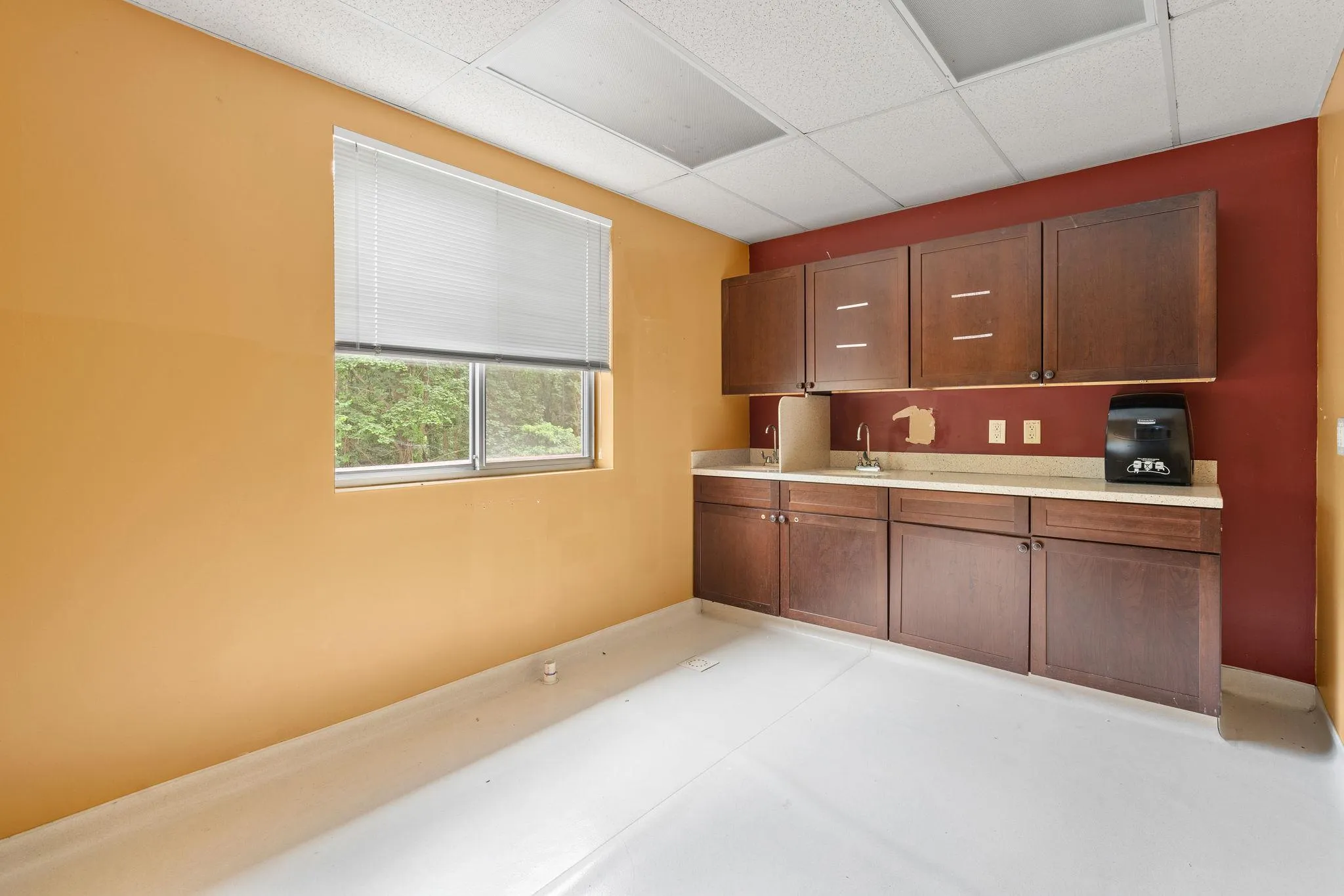 Kitchen with a paneled ceiling and light countertops Kitchen with a paneled ceiling and light countertops
