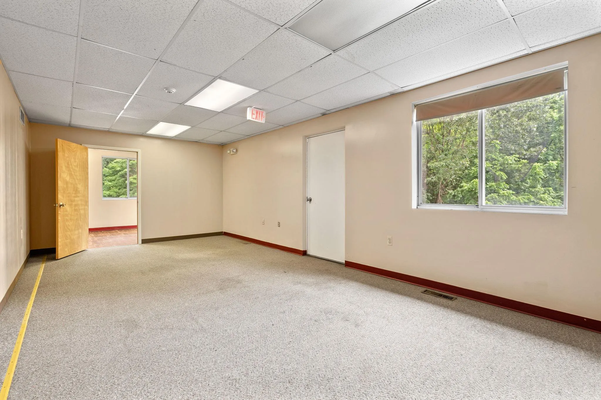 Carpeted spare room featuring a drop ceiling Carpeted spare room featuring a drop ceiling