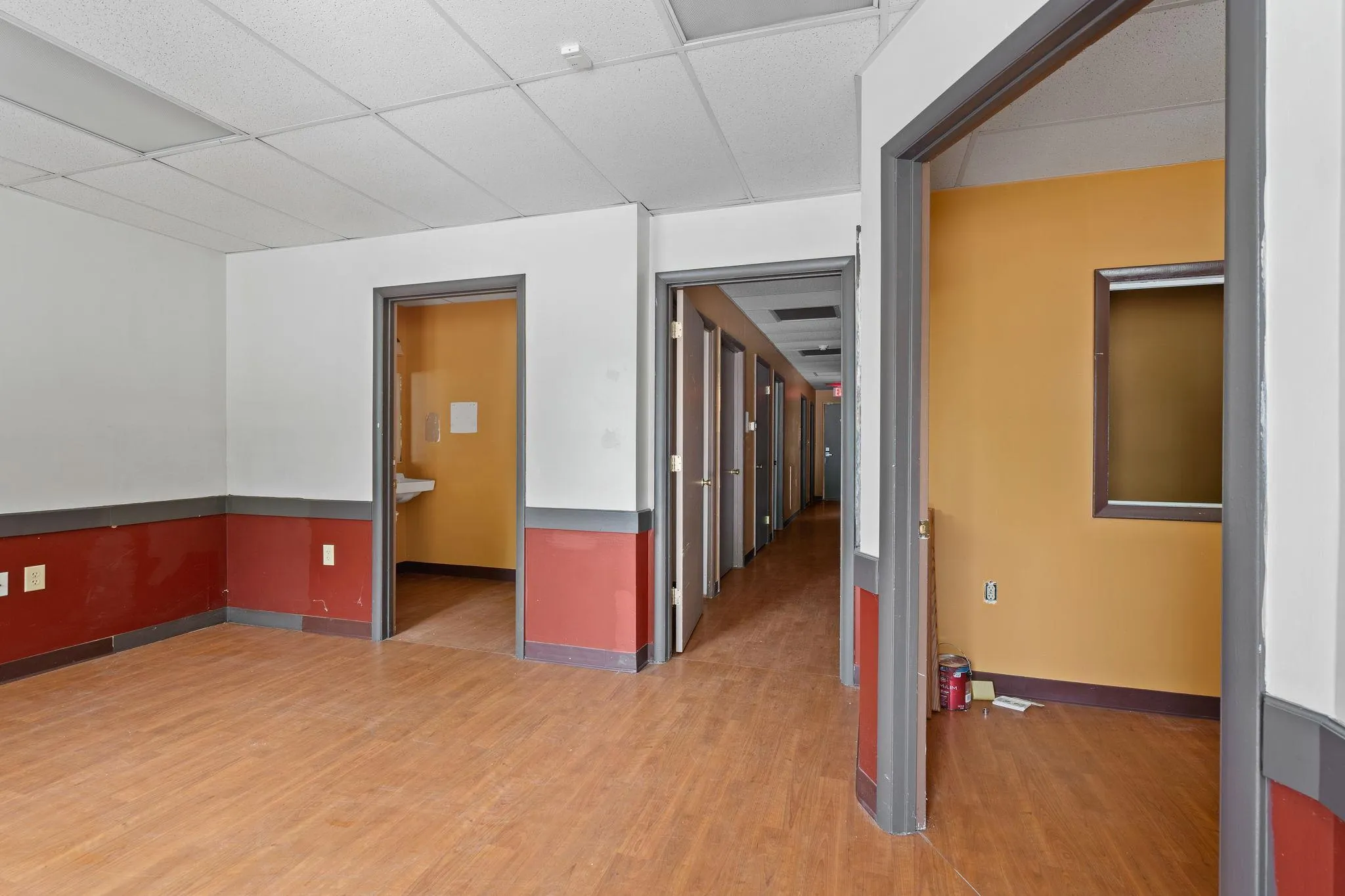 Empty room featuring light wood-type flooring and a paneled ceiling Empty room featuring light wood-type flooring and a paneled ceiling