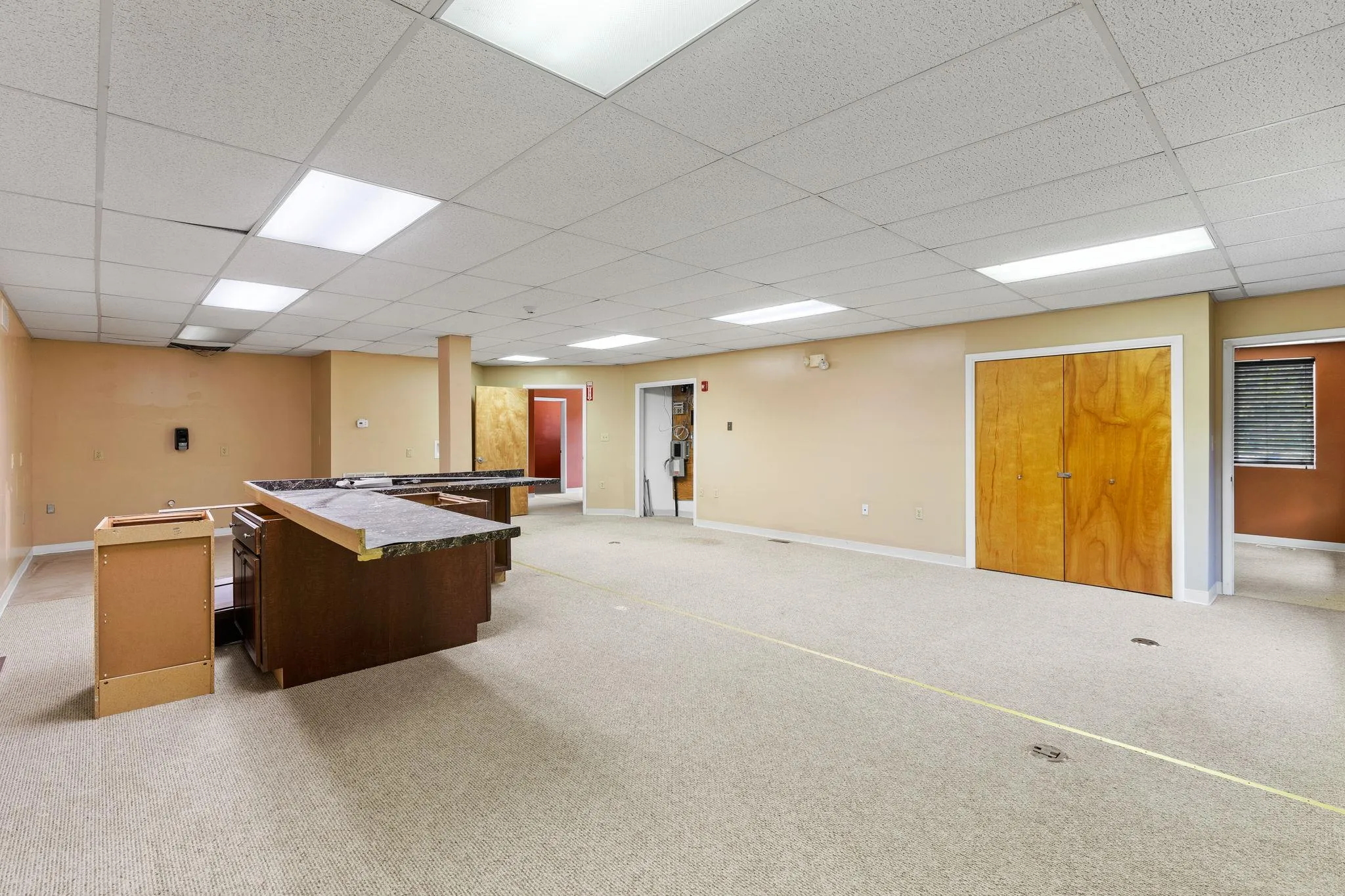 Recreation room featuring a drop ceiling and light carpet Recreation room featuring a drop ceiling and light carpet