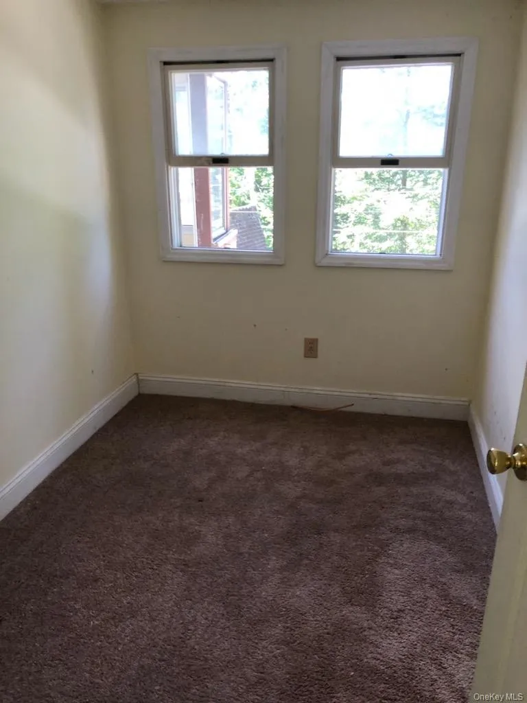 Unfurnished room featuring carpet floors and baseboards Unfurnished room featuring carpet floors and baseboards
