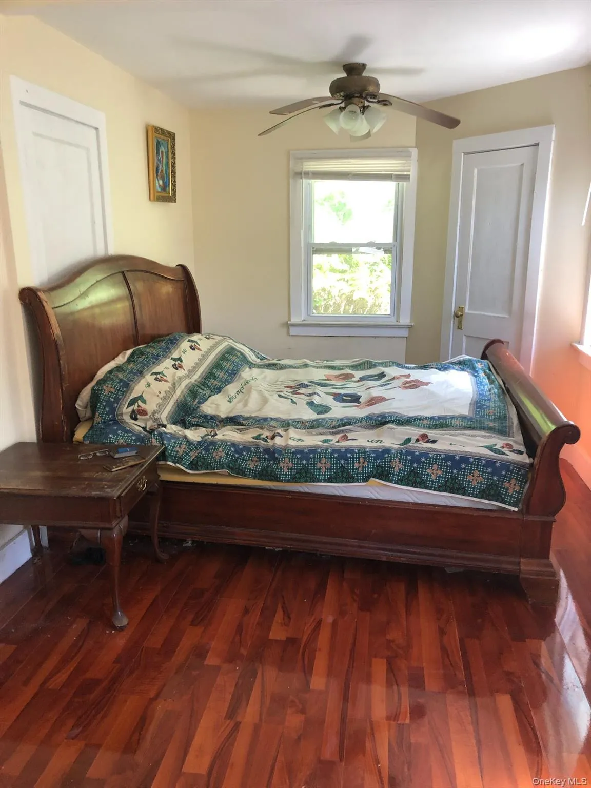 Bedroom with wood finished floors and ceiling fan Bedroom with wood finished floors and ceiling fan