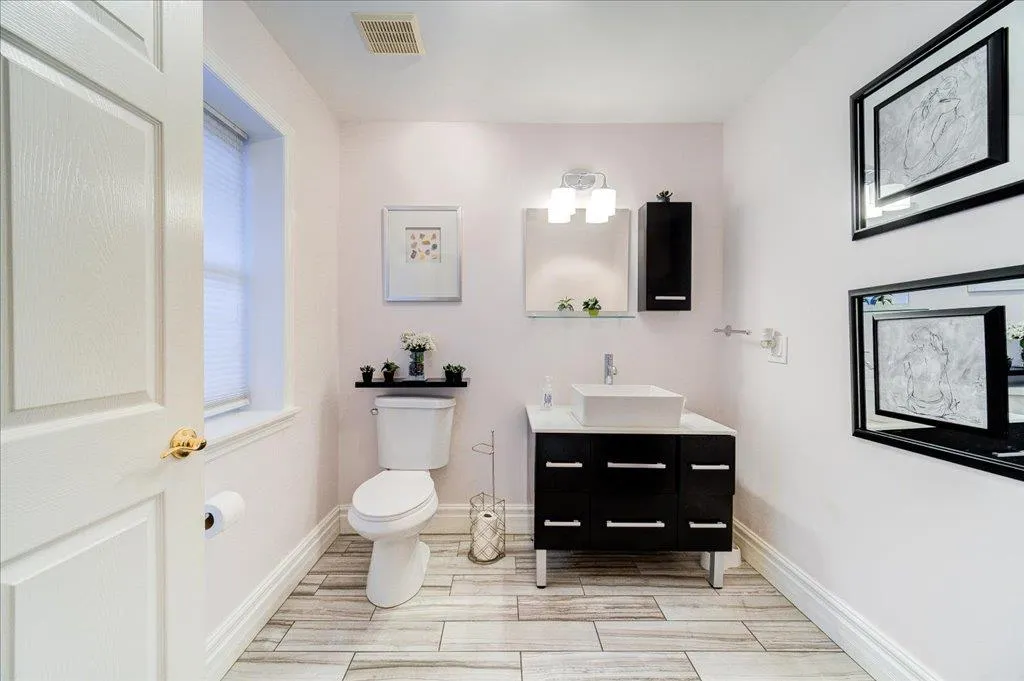 Bathroom featuring vanity and toilet Bathroom featuring vanity and toilet