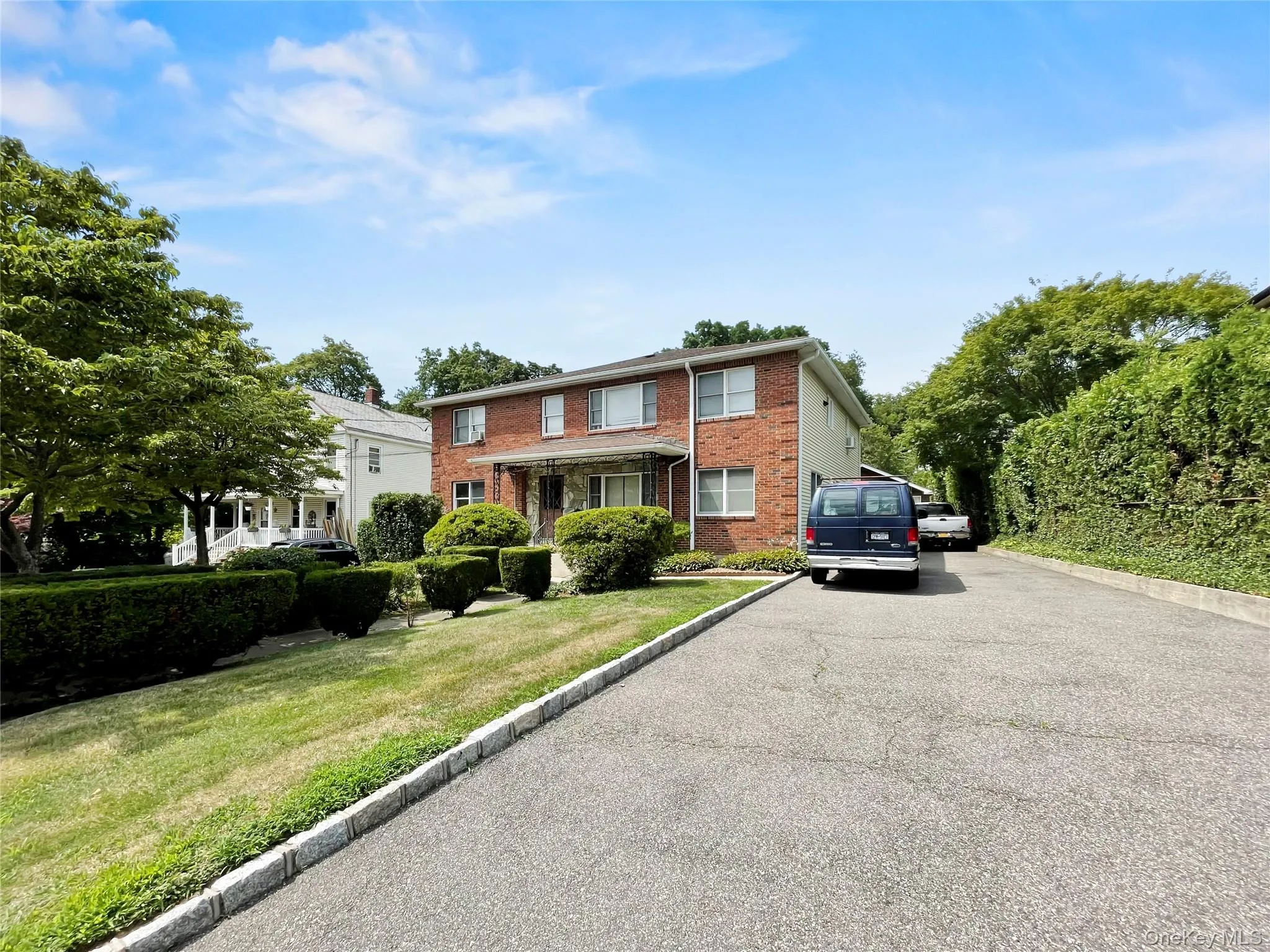 View of front of home featuring brick siding and a front yard View of front of home featuring brick siding and a front yard