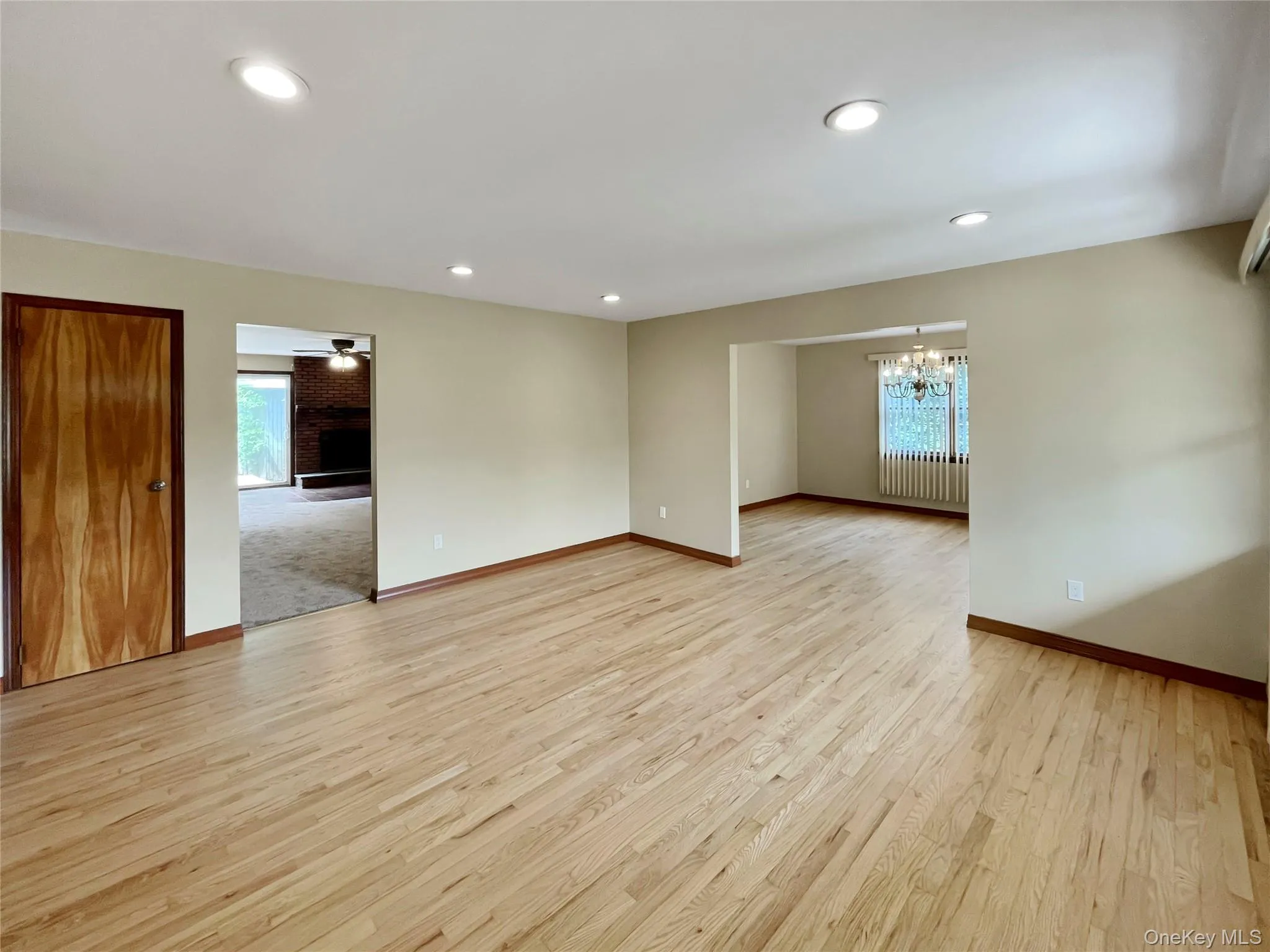 Spare room with a chandelier, light wood-type flooring, and recessed lighting Spare room with a chandelier, light wood-type flooring, and recessed lighting