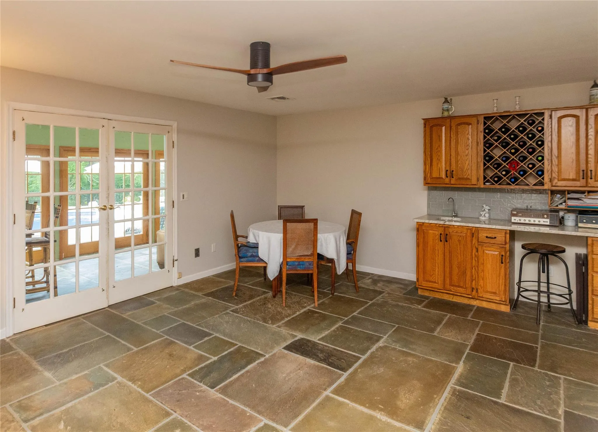 Dining area featuring french doors, stone tile floors Dining area featuring french doors, stone tile floors