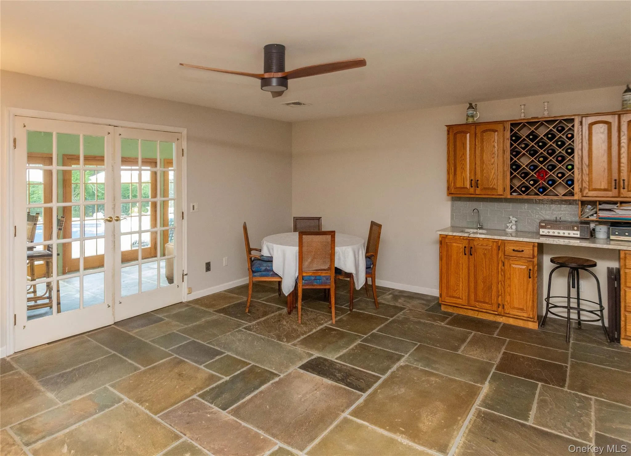 Dining area featuring french doors, stone tile floors Dining area featuring french doors, stone tile floors